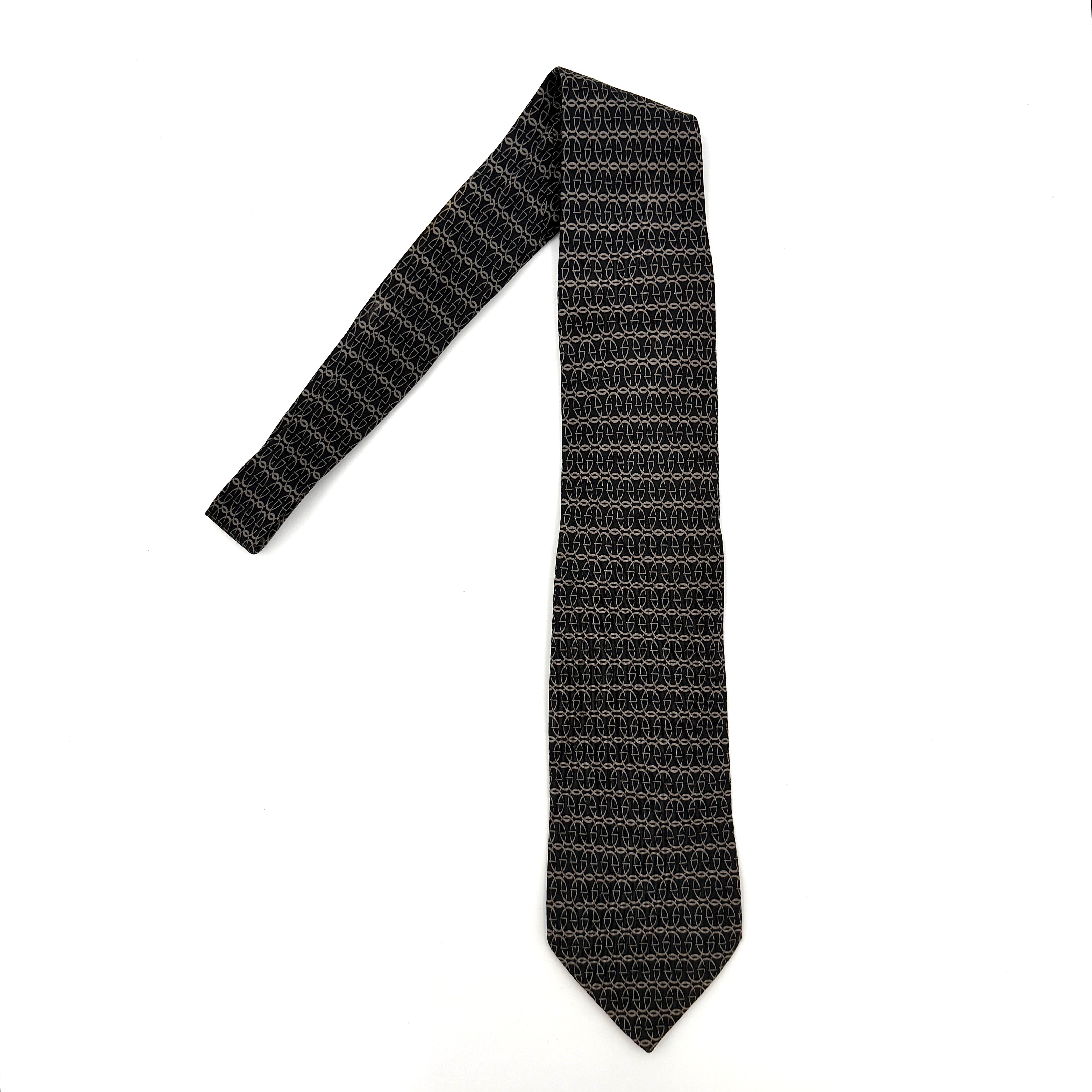 Gucci GG monogram silk tie in black featuring the iconic interlocking GG pattern and a sleek woven finish.