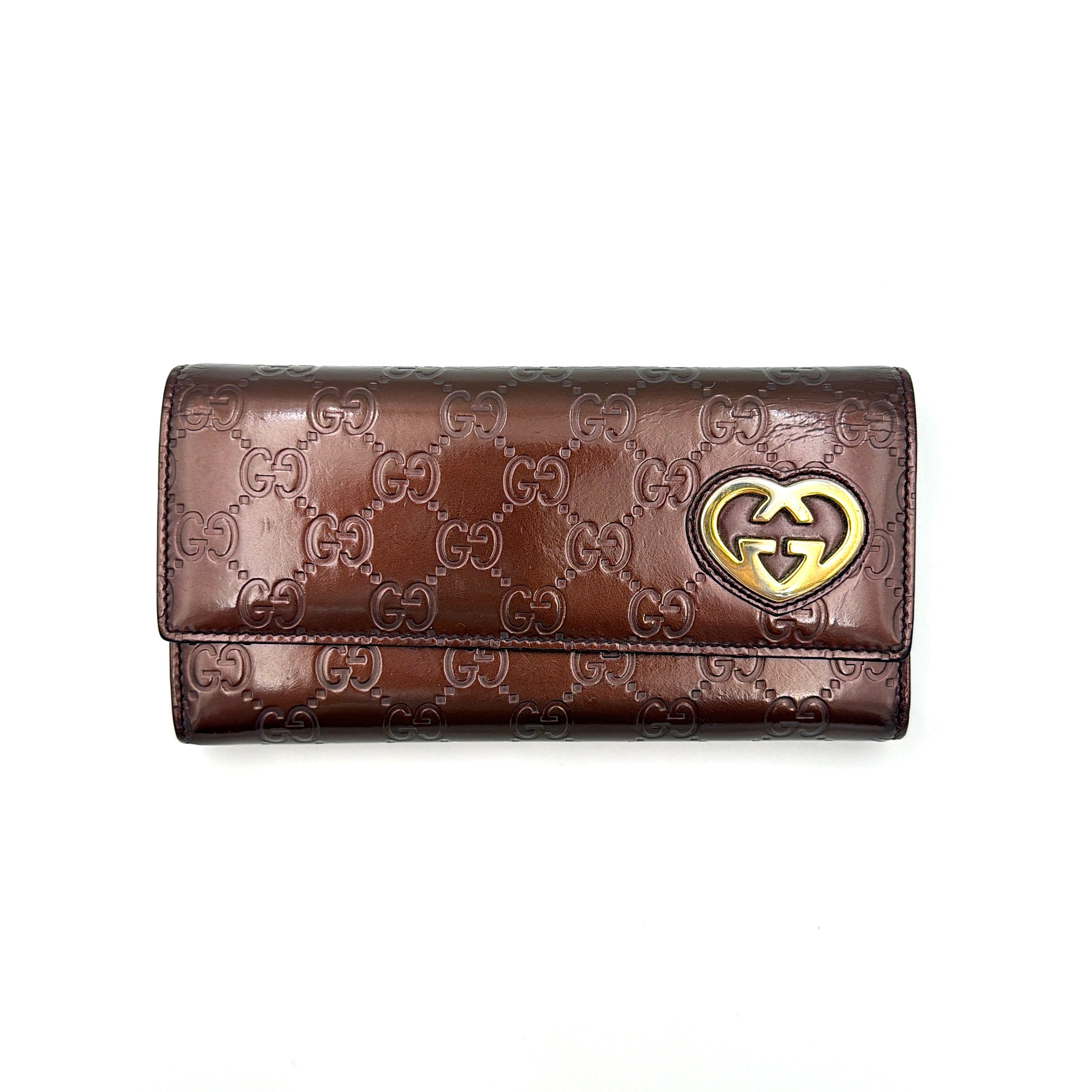 Gucci Guccissima heart continental wallet in burgundy embossed leather with gold-tone heart GG logo.