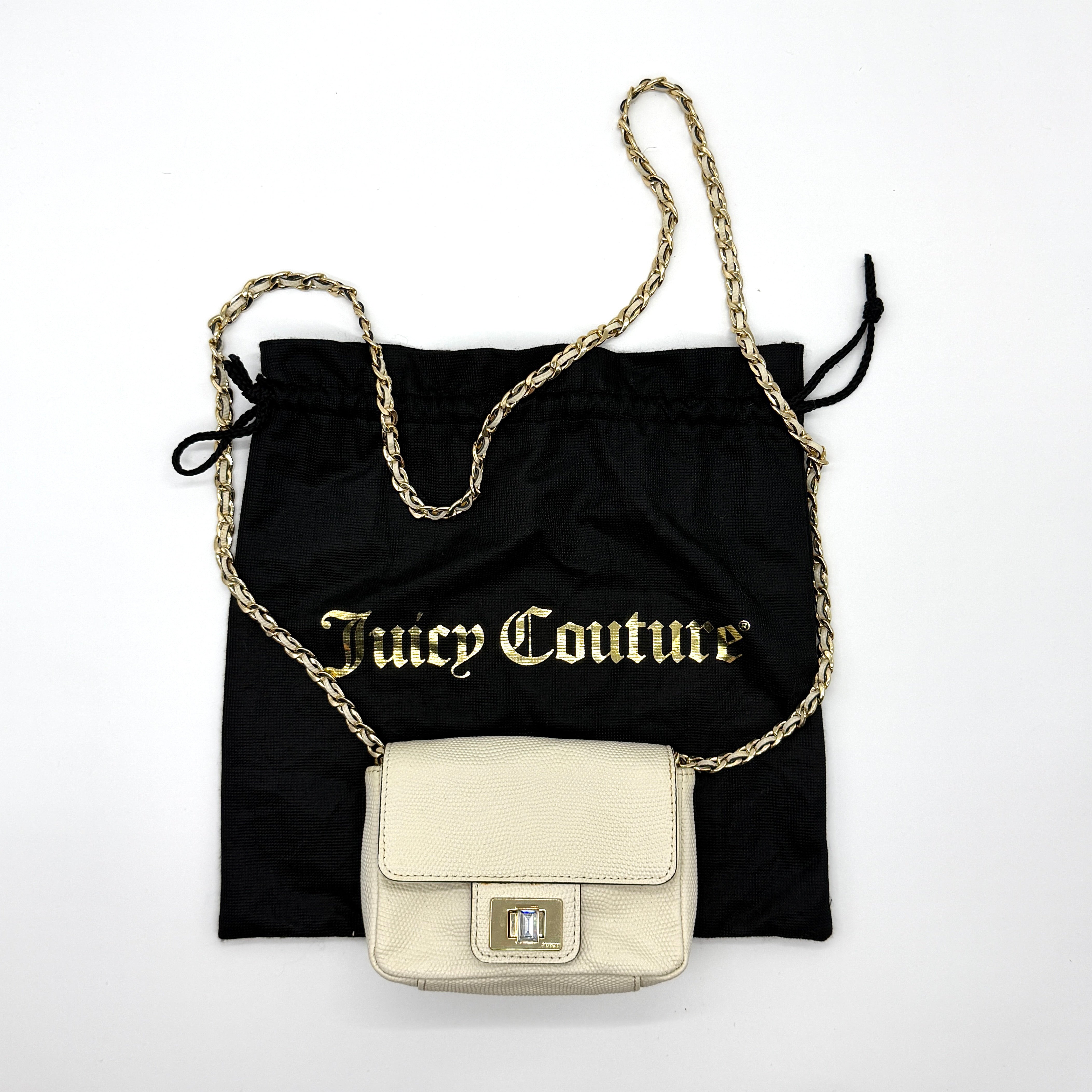 Juicy Couture cream mini crossbody bag with gold chain strap and gem clasp closure.