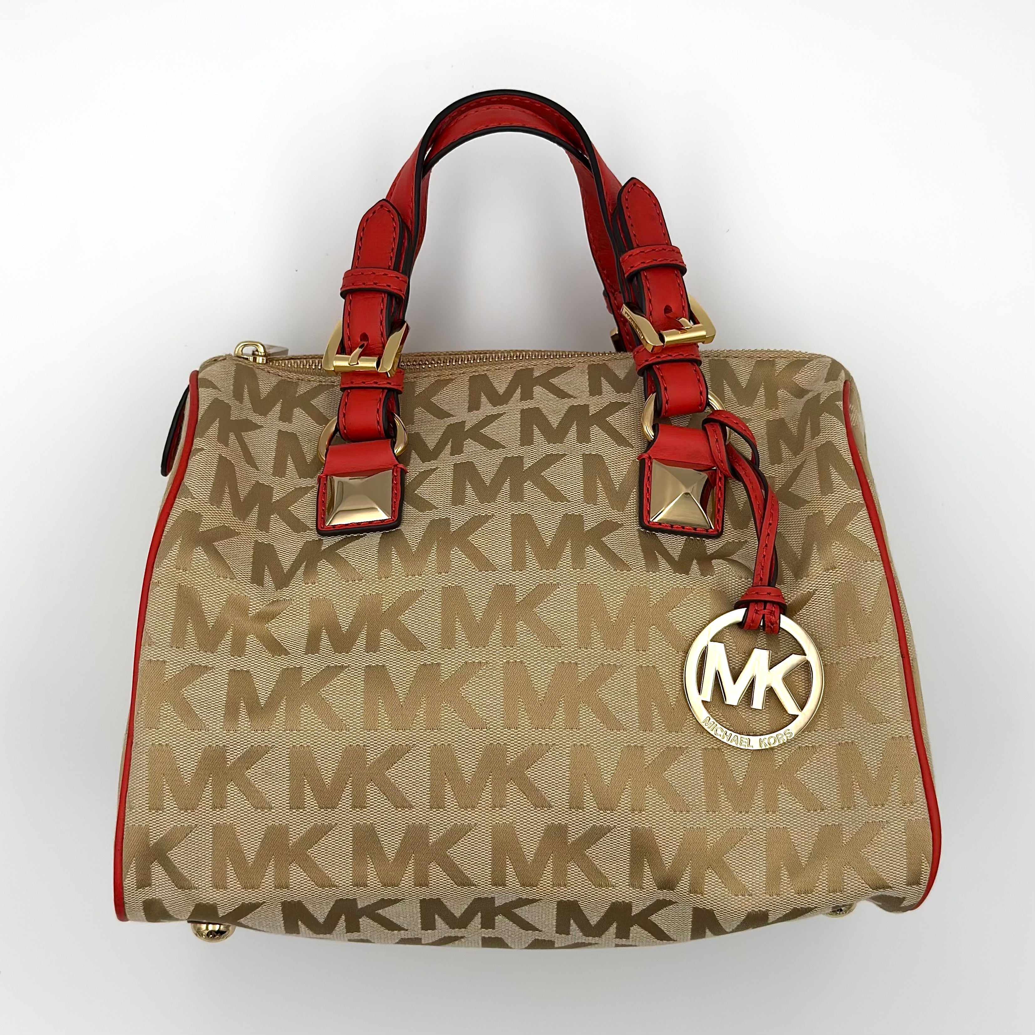 Michael Kors Grayson Monogram Satchel Handbag in beige with red leather trim, gold-tone hardware, MK monogram design, dual handles, and spacious zippered interior.