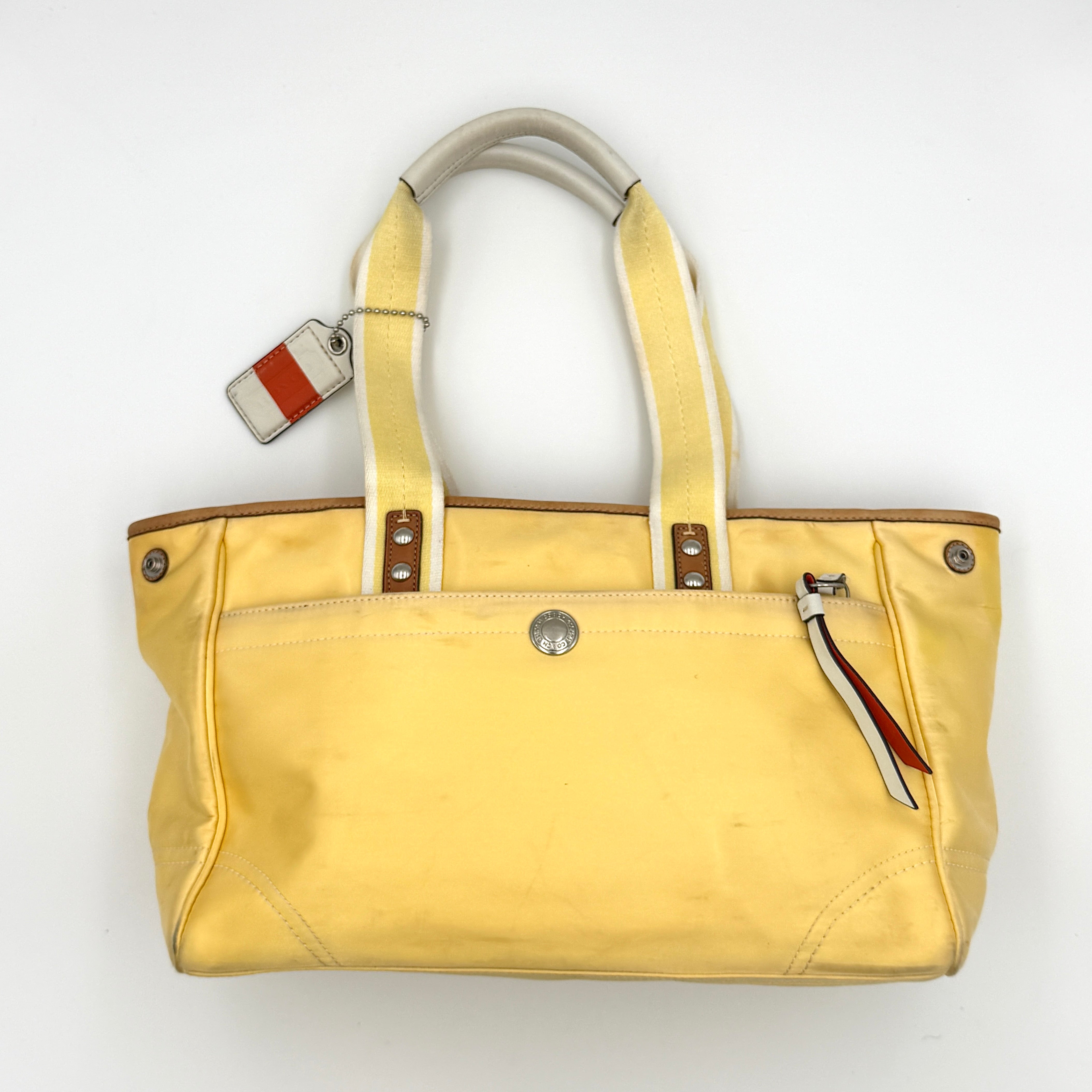 Coach Hampton Sateen Satchel Bag in yellow fabric with leather trim, silver-tone hardware, and dual top handles.