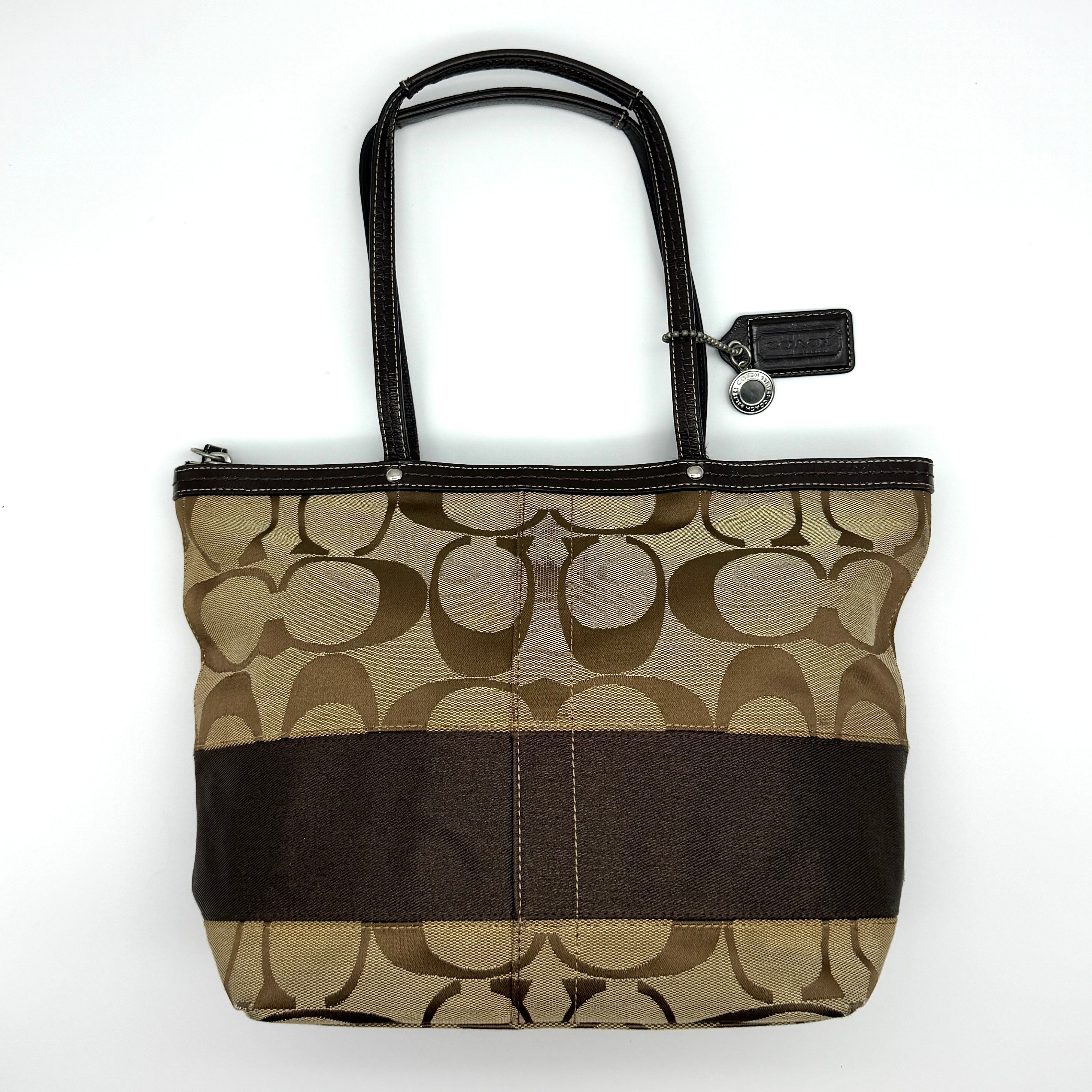 Coach Signature Stripe Tote Bag in beige and brown jacquard canvas with leather trim and silver-tone hardware.