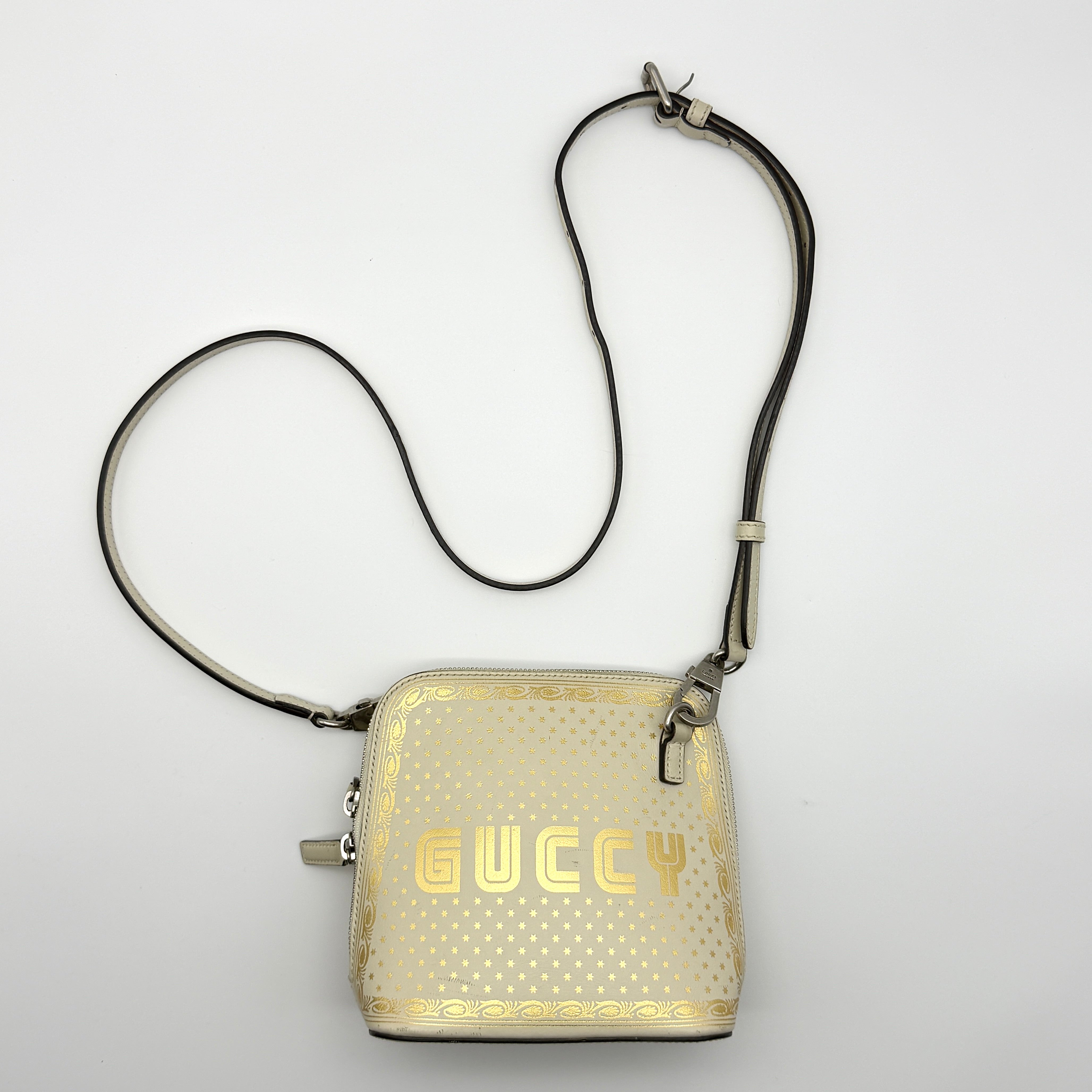 Gucci Guccy Mini Dome Crossbody Bag in white leather with gold star detailing and silver-tone hardware