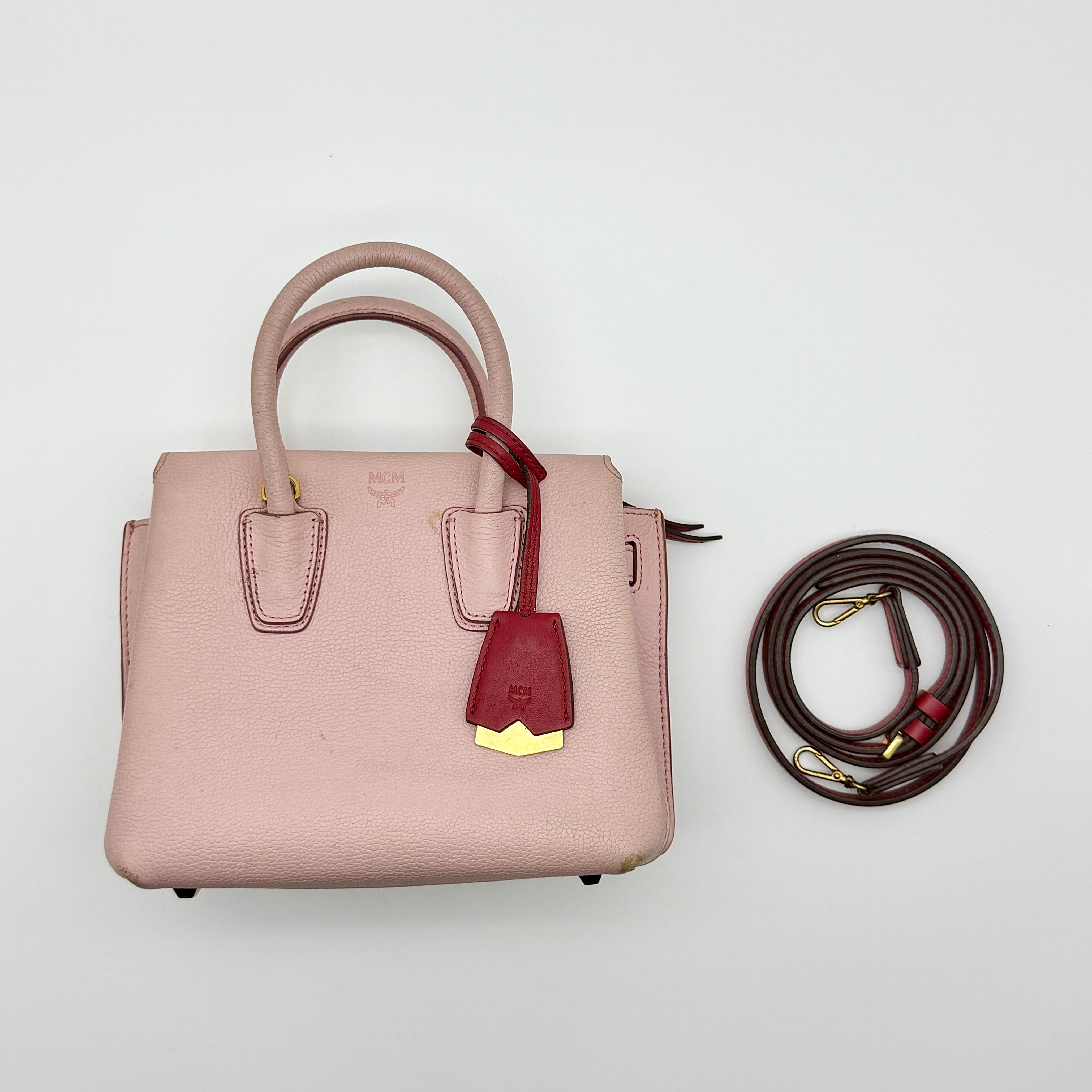 MCM 2Way Milla Mini Handbag in pink pebbled leather with red trim and gold-tone hardware