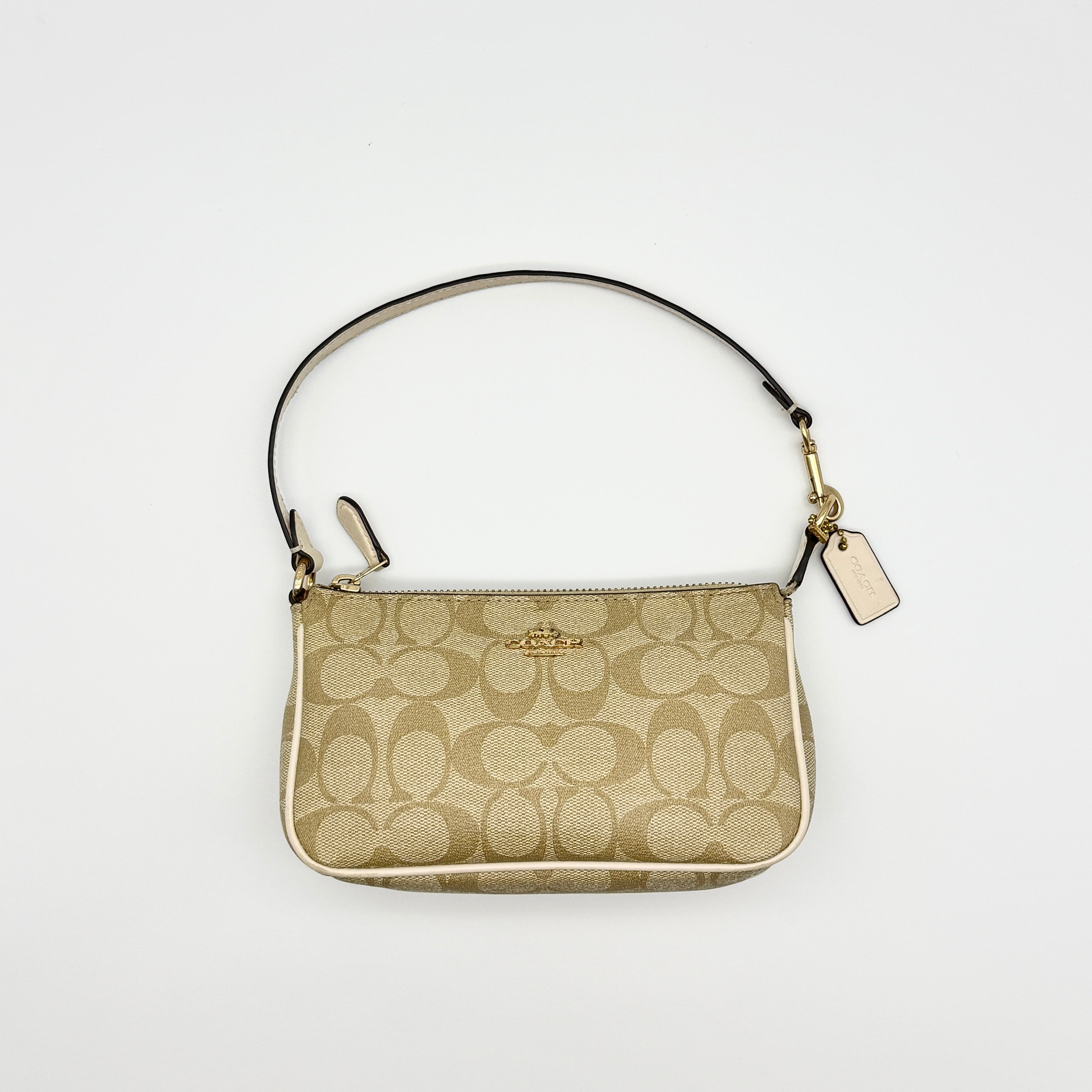 Preloved luxury vintage Coach Signature Nolita 19 Shoulder Bag in beige monogram canvas with ivory leather trim and gold hardware