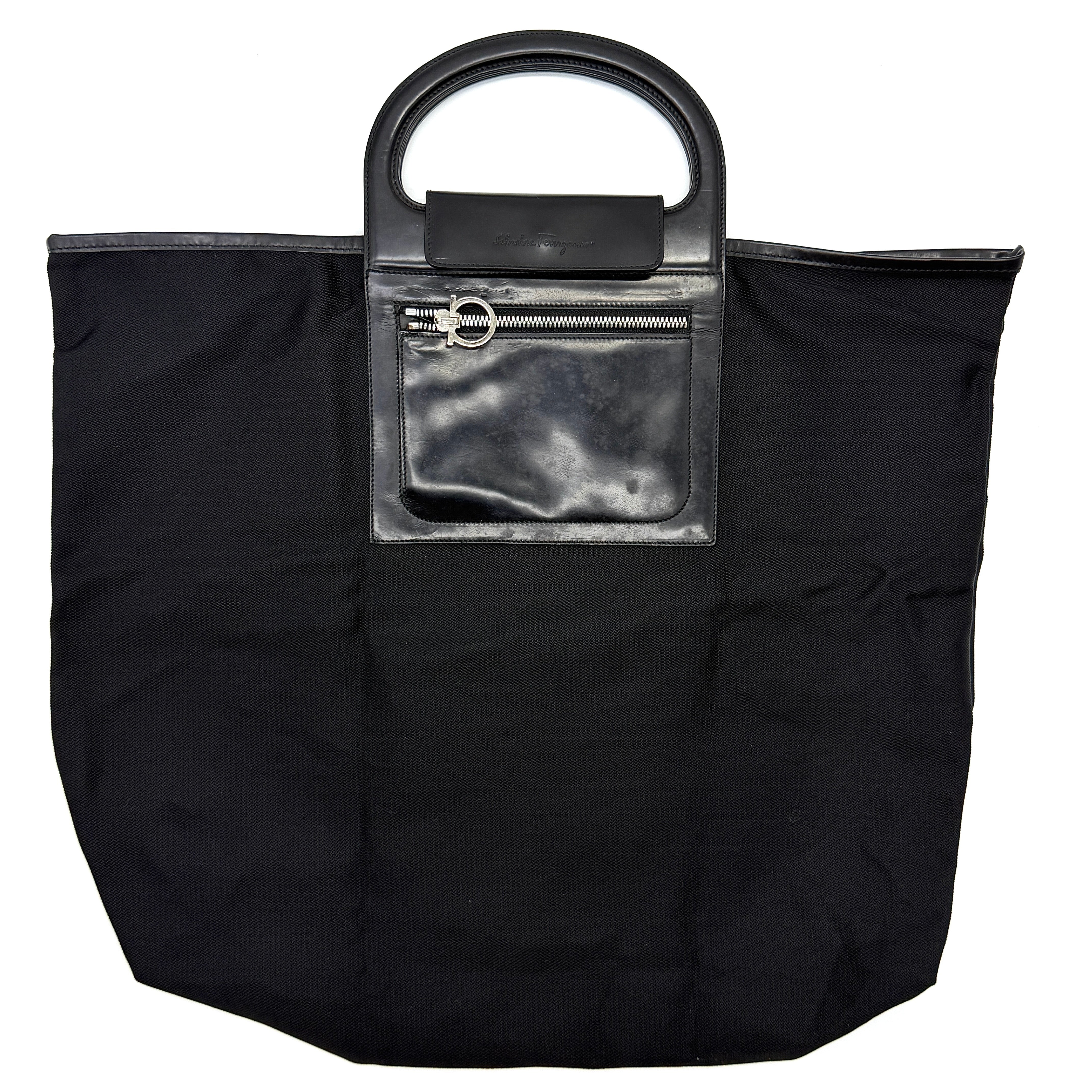 Black Salvatore Ferragamo foldable nylon handbag with leather handle and Gancini zip pocket.