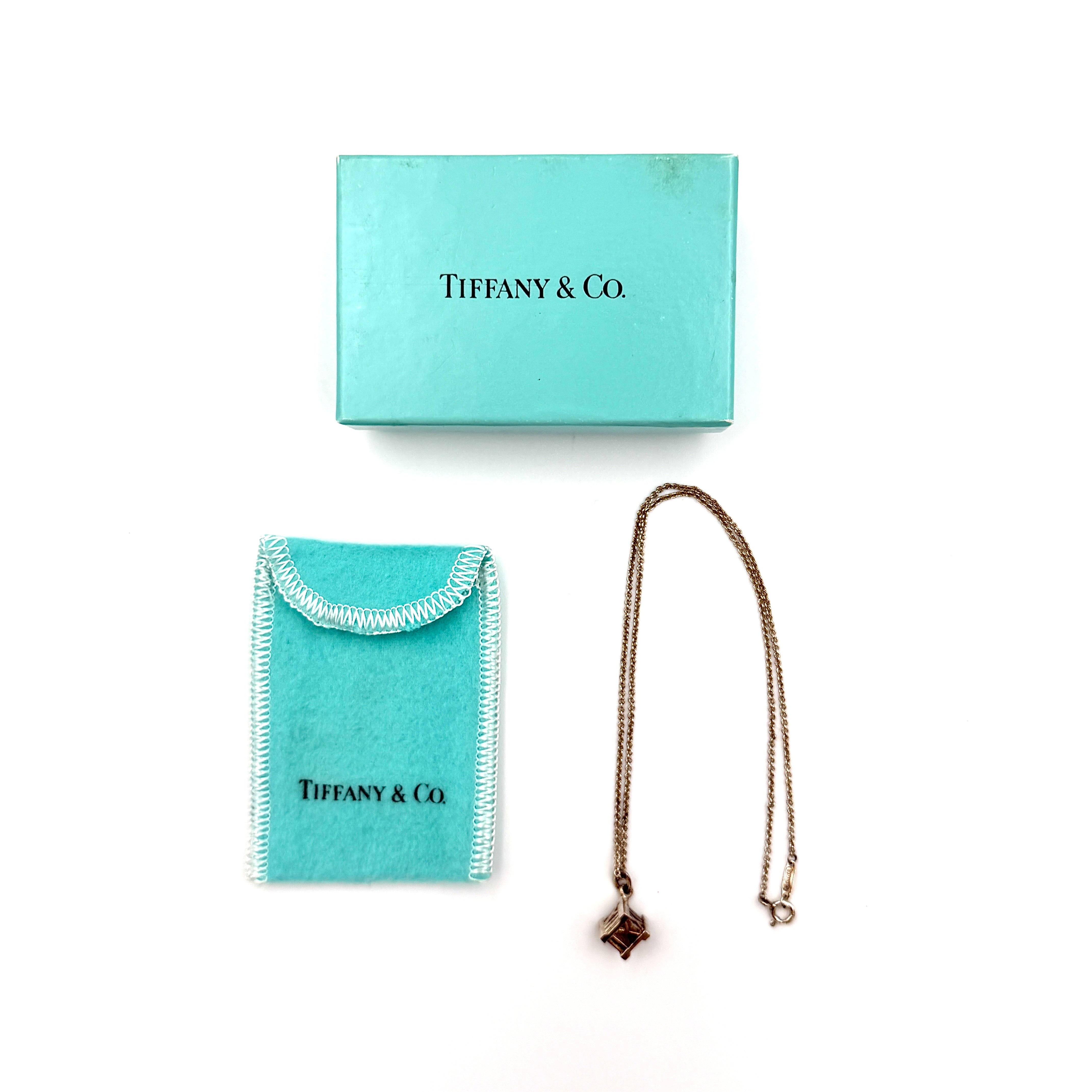 Tiffany & Co. Atlas cube necklace in sterling silver featuring Roman numeral engraved pendant on fine chain.