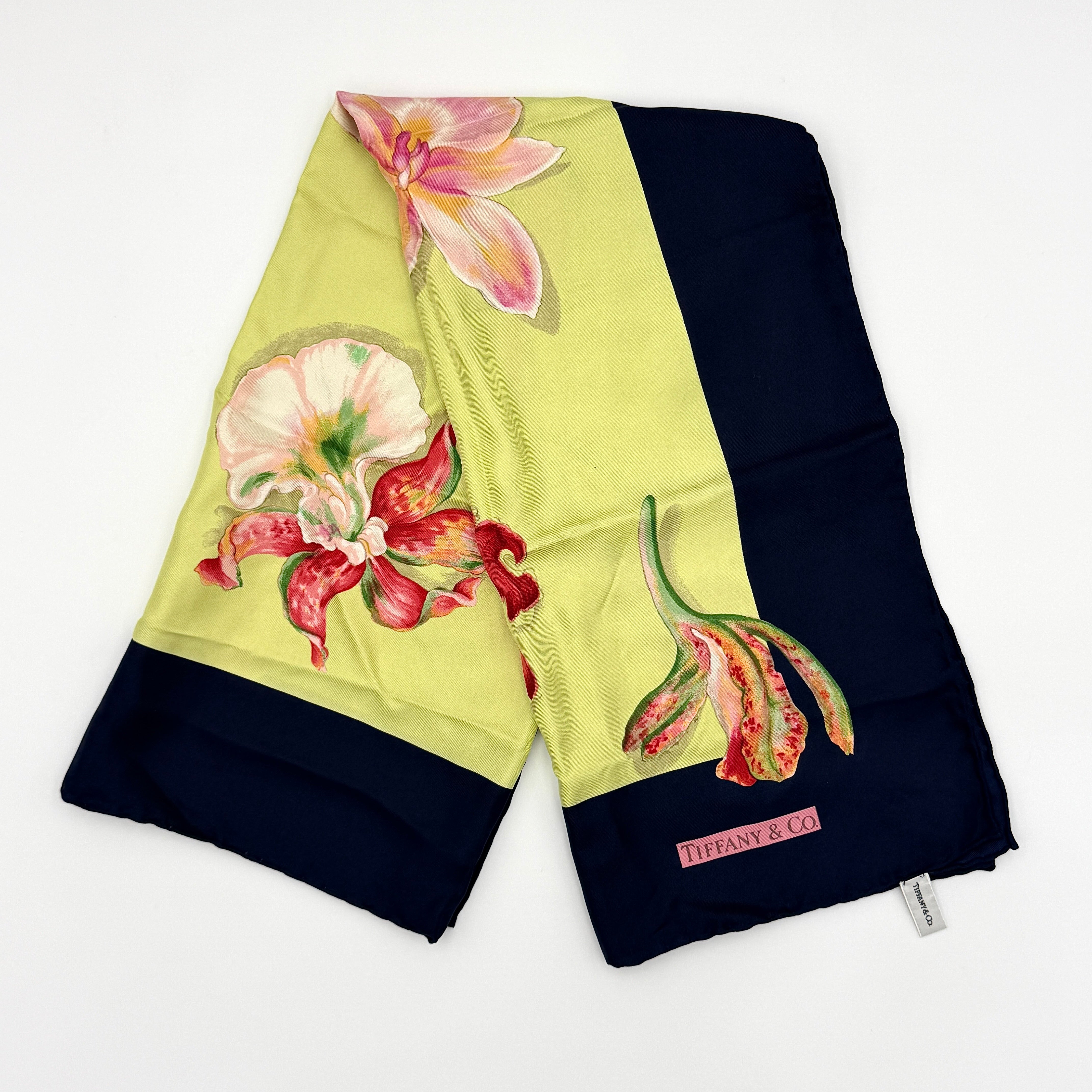 Tiffany & Co. multicolor floral silk scarf with vibrant floral patterns and contrasting dark borders.