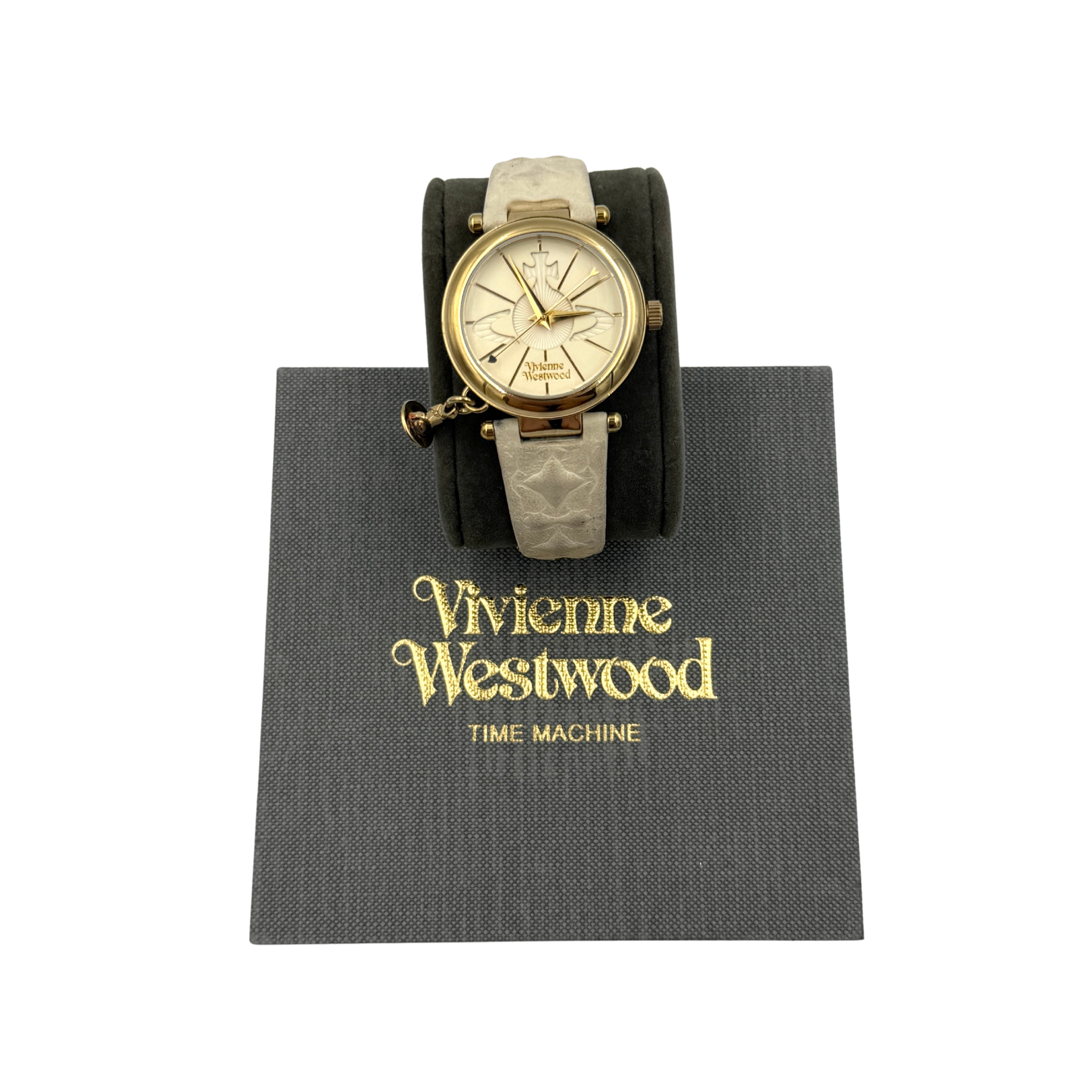 Vivienne Westwood Orb VV006WHWH watch featuring a gold-tone round dial with orb detailing and a beige strap, shown with Vivienne Westwood box packaging.