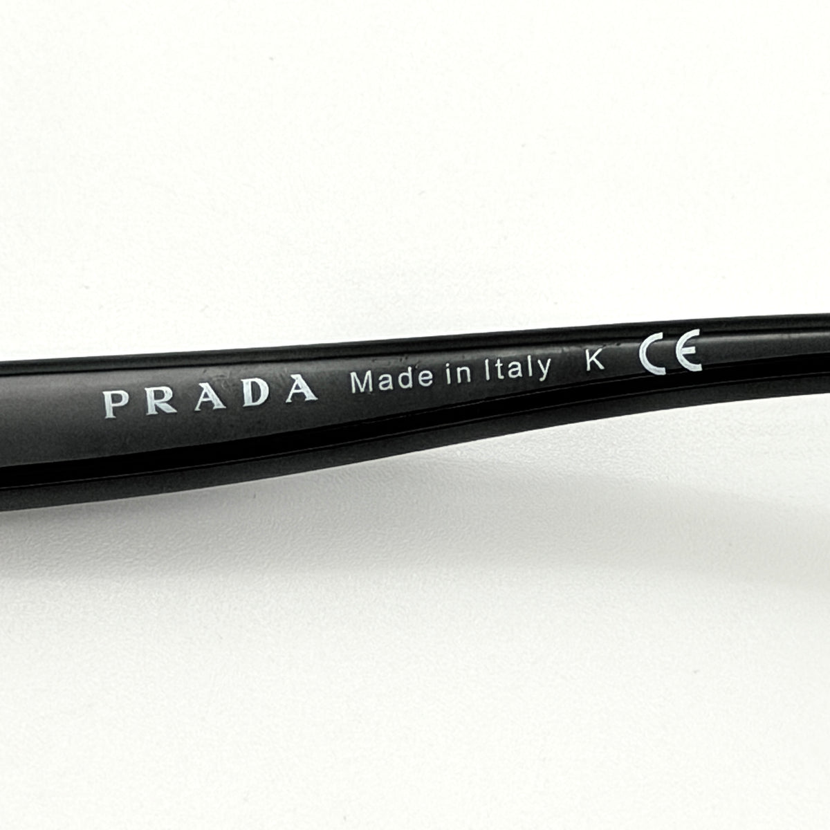 Prada SPR080 sunglasses featuring a brown and blush oversized frame with gradient lenses and silver hardware at the temples.