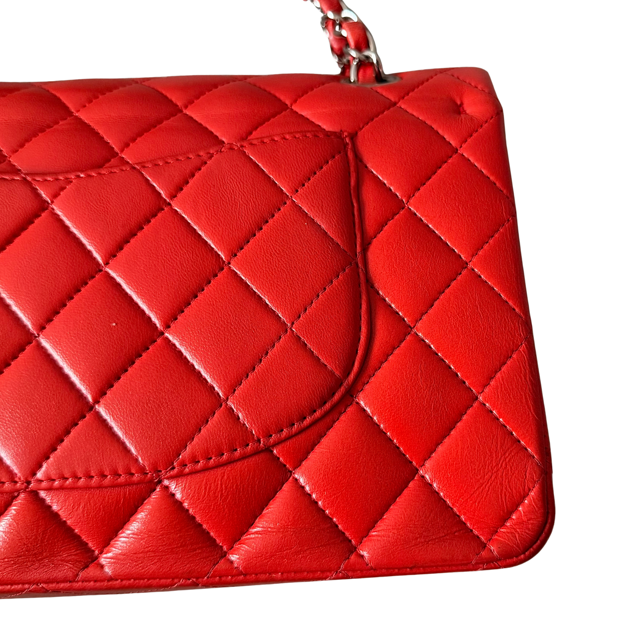 Chanel double flap shoulder bag in quilted red leather with silver-tone hardware and chain leather strap.