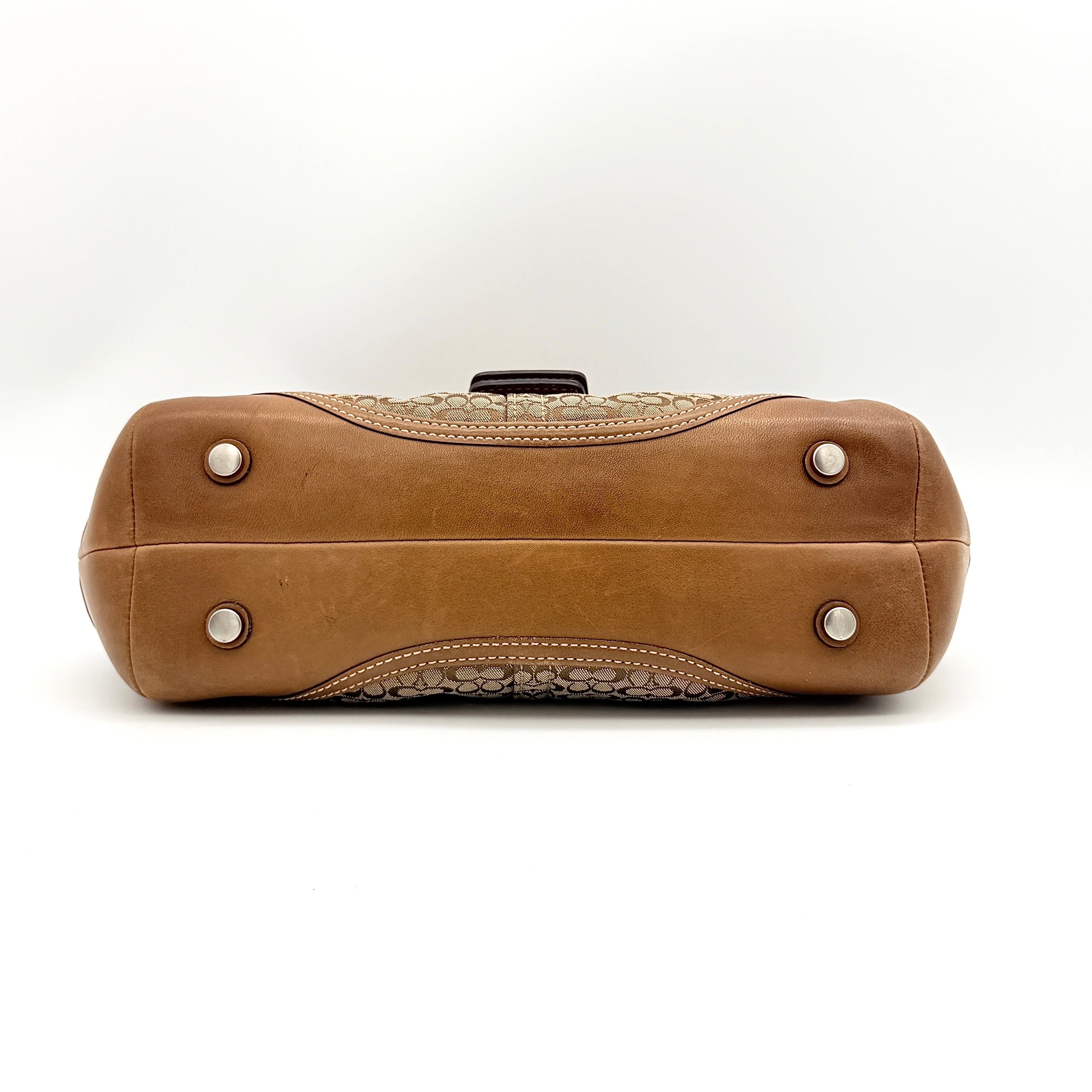 Coach Signature Soho Shoulder Bag in beige and tan monogram canvas with tan leather trim, shown on white background.