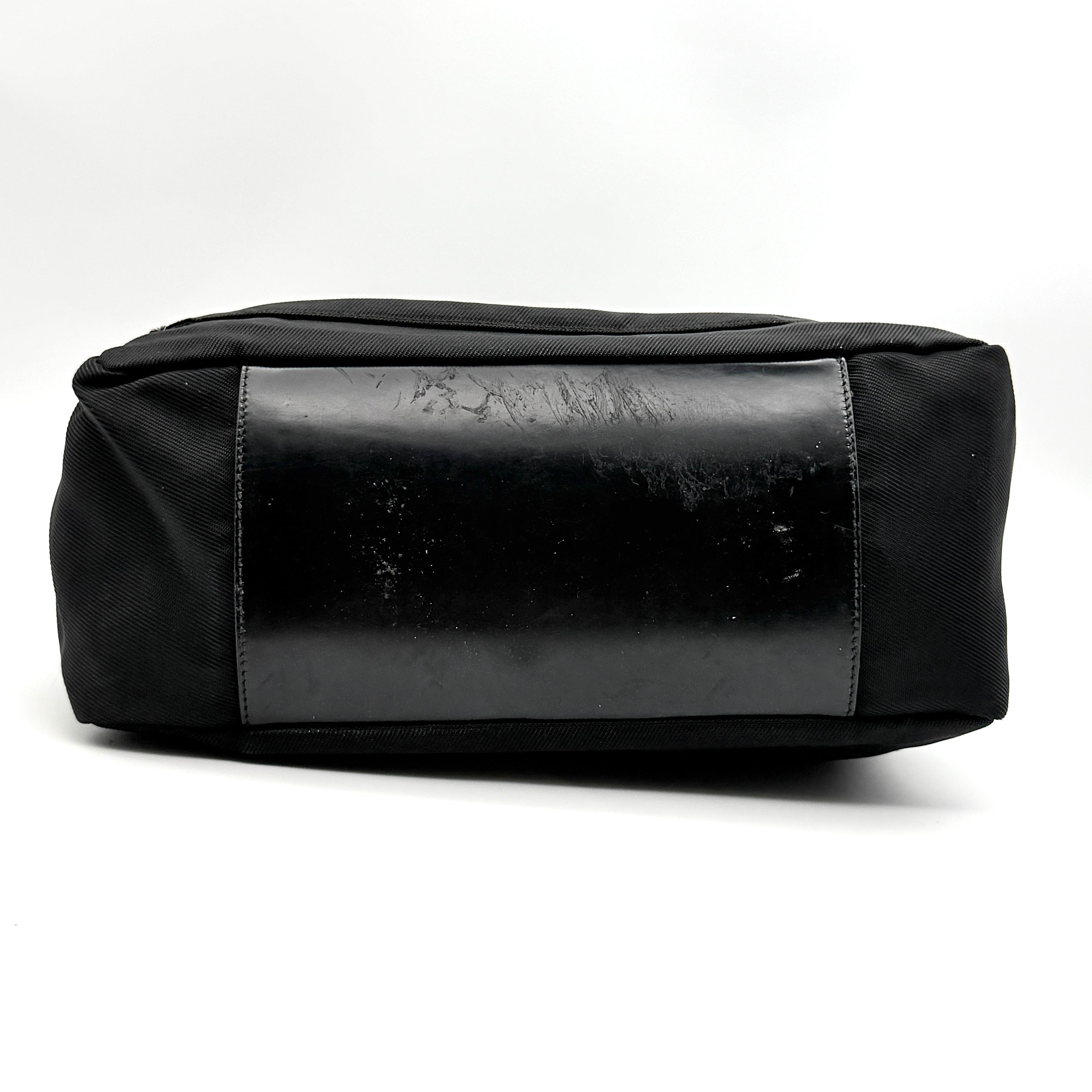 Gucci nylon shoulder bag in black with bamboo handle, shown against a white background.