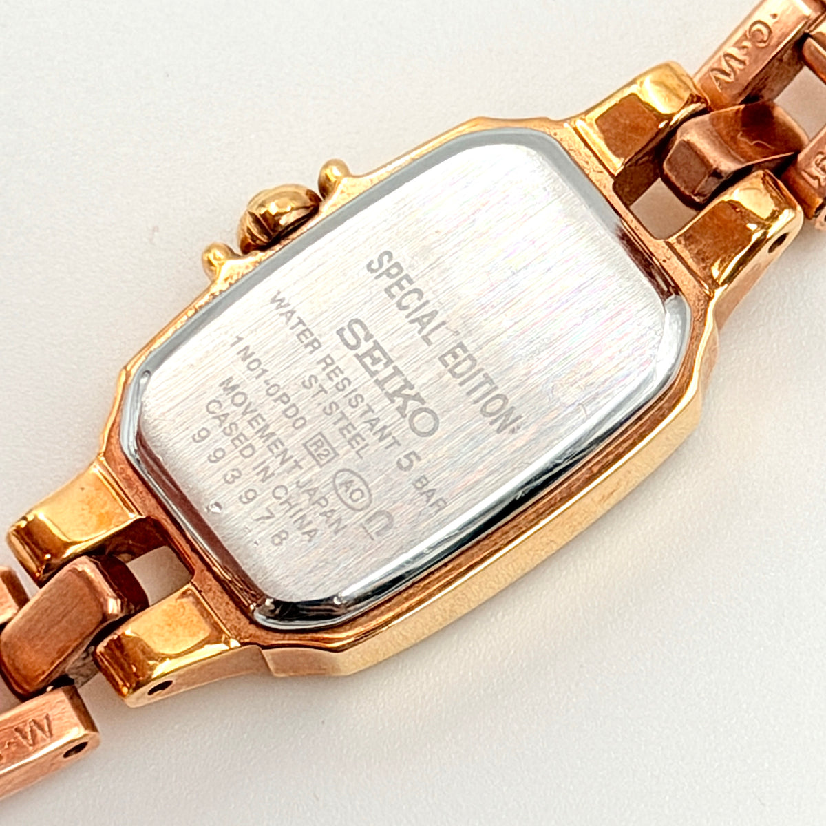 Front view of the Seiko Tisse Nozomi Special Edition watch with a pink heart motif dial and two-tone gold and rose gold bracelet.