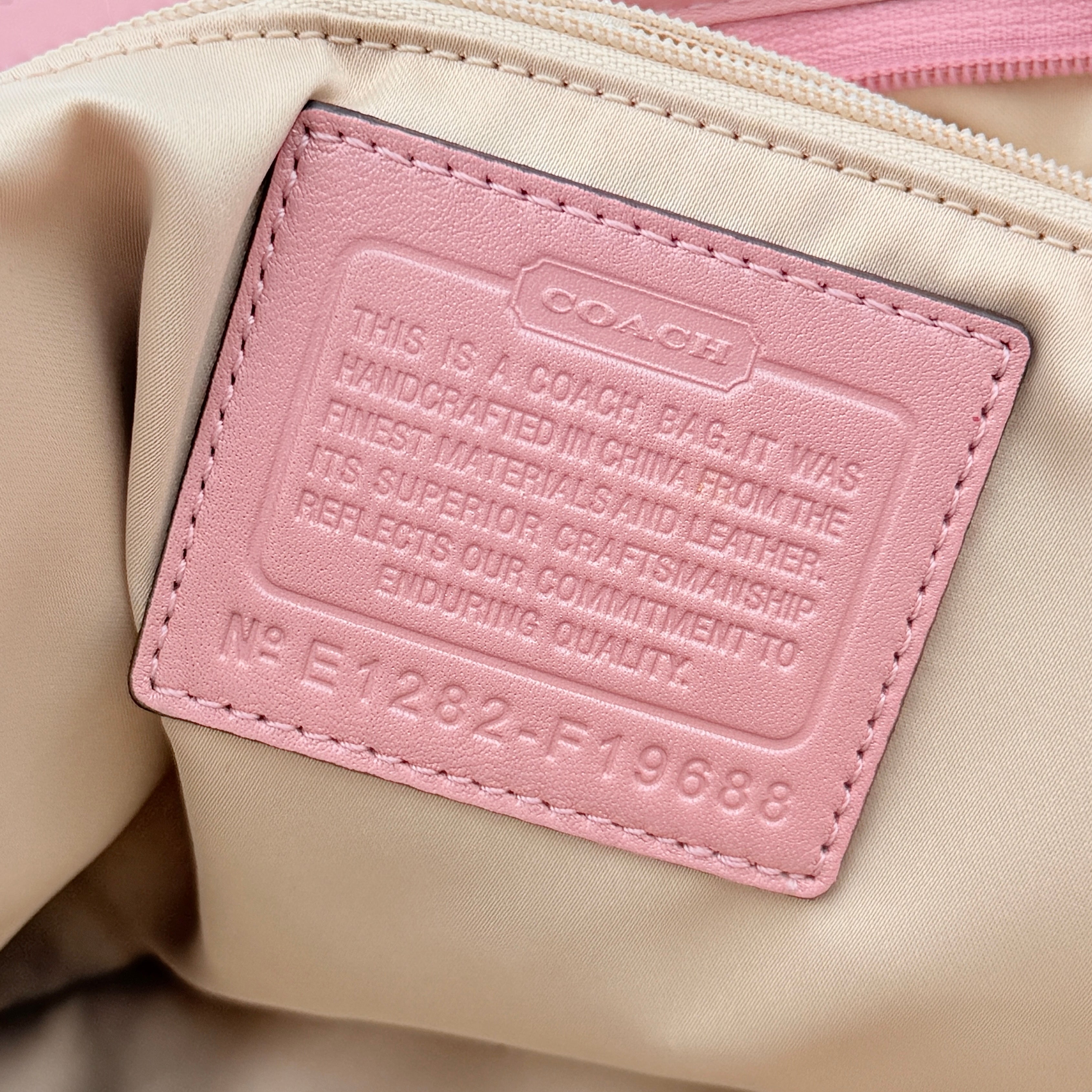 Coach 2Way Perforated Shoulder Bag in soft pink leather with silver hardware and detachable strap, displayed on a white background.