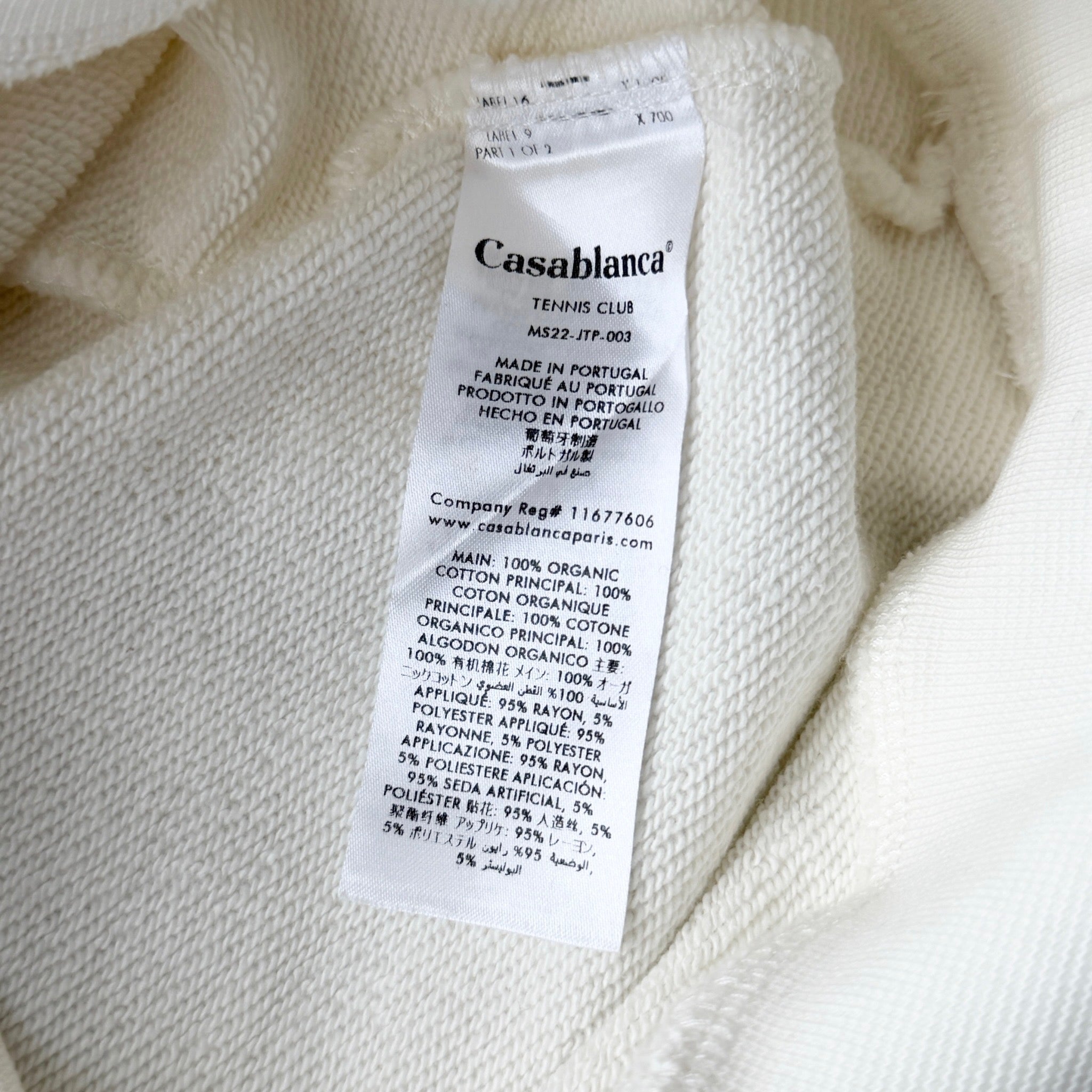 Casablanca off-white hoodie with a red logo patch and kangaroo pocket, laid flat and showing the front view.
