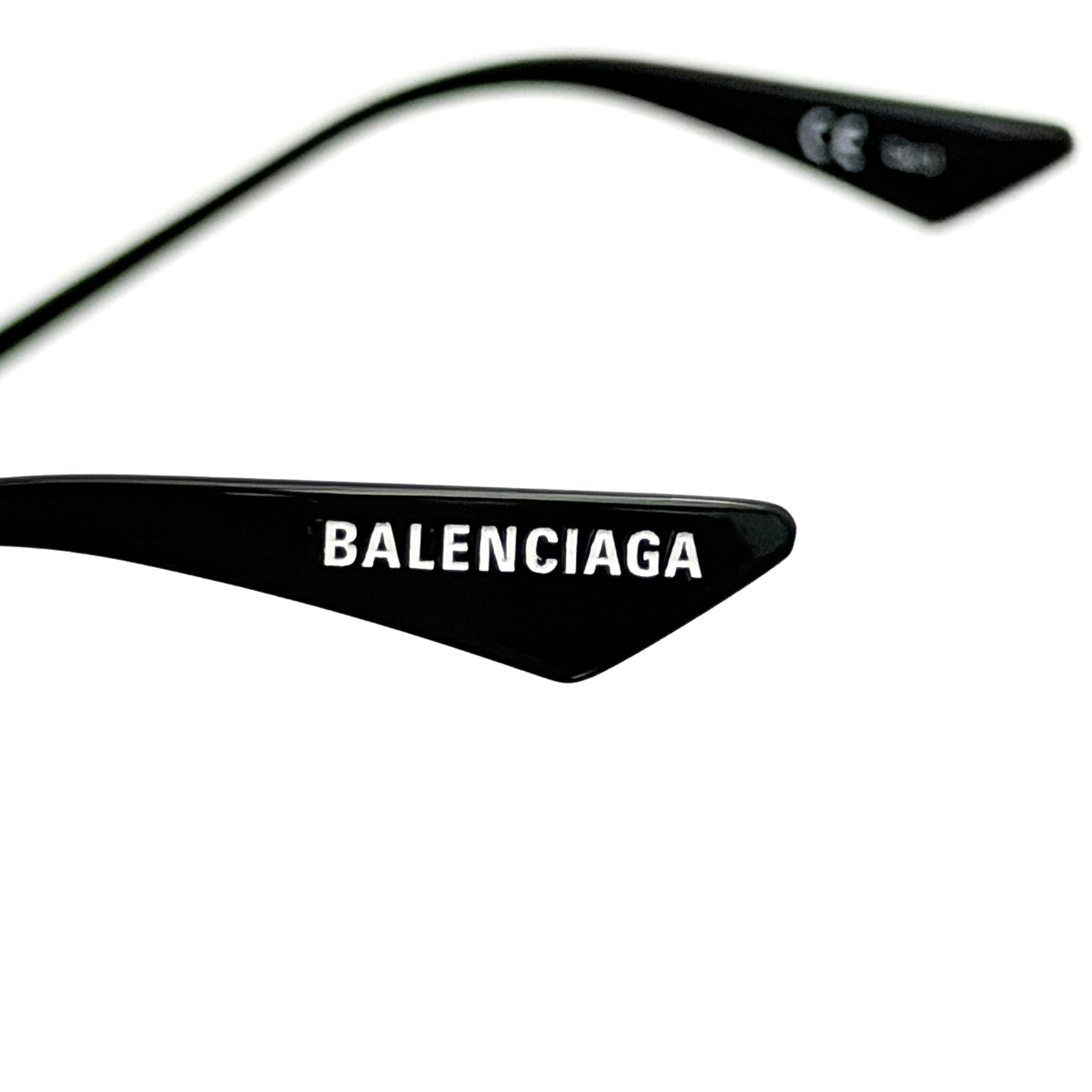 Balenciaga cat-eye sunglasses with purple mirrored lenses and black frame, featuring signature BB logo at the bridge.