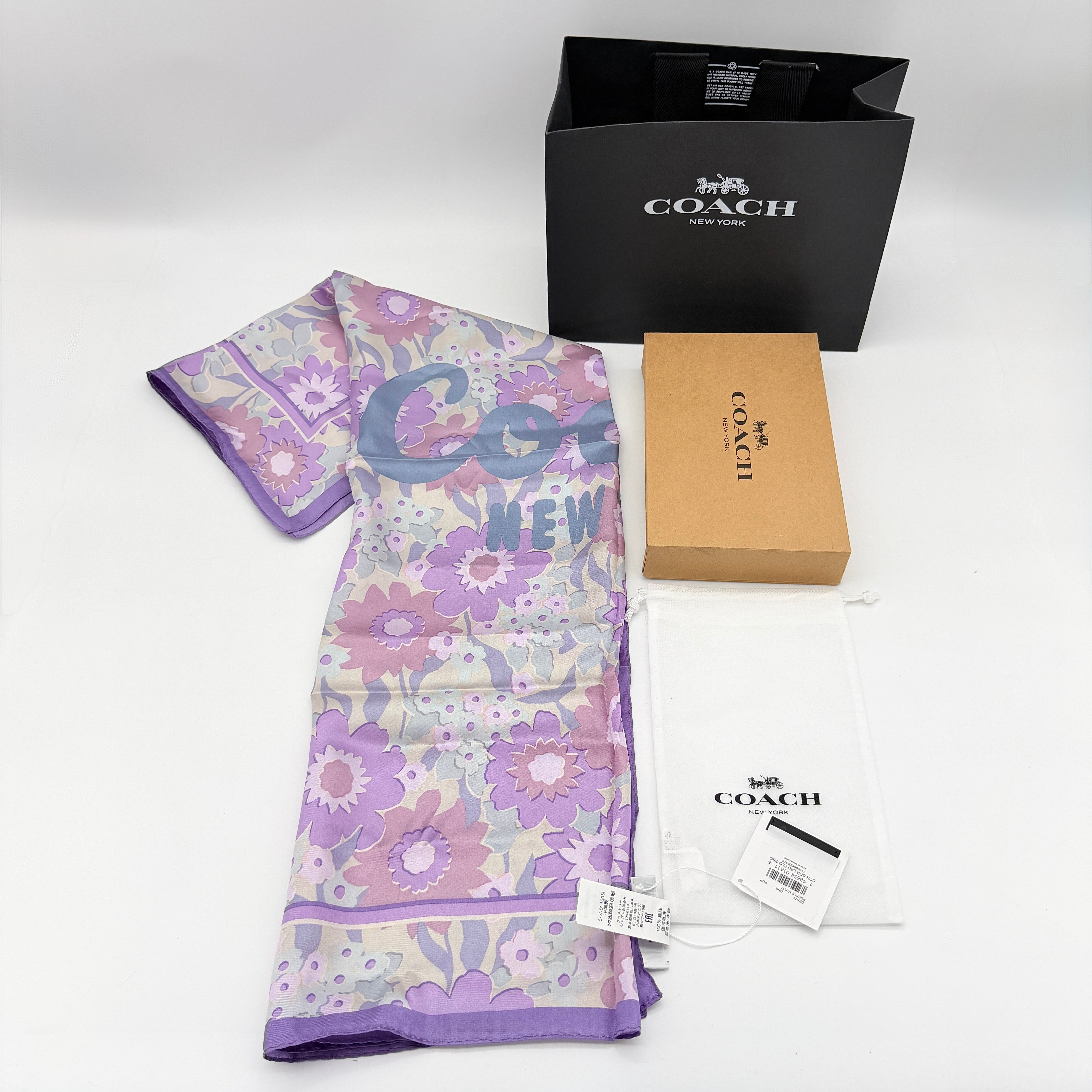 Coach floral silk scarf in purple with logo, presented with original packaging and tags.