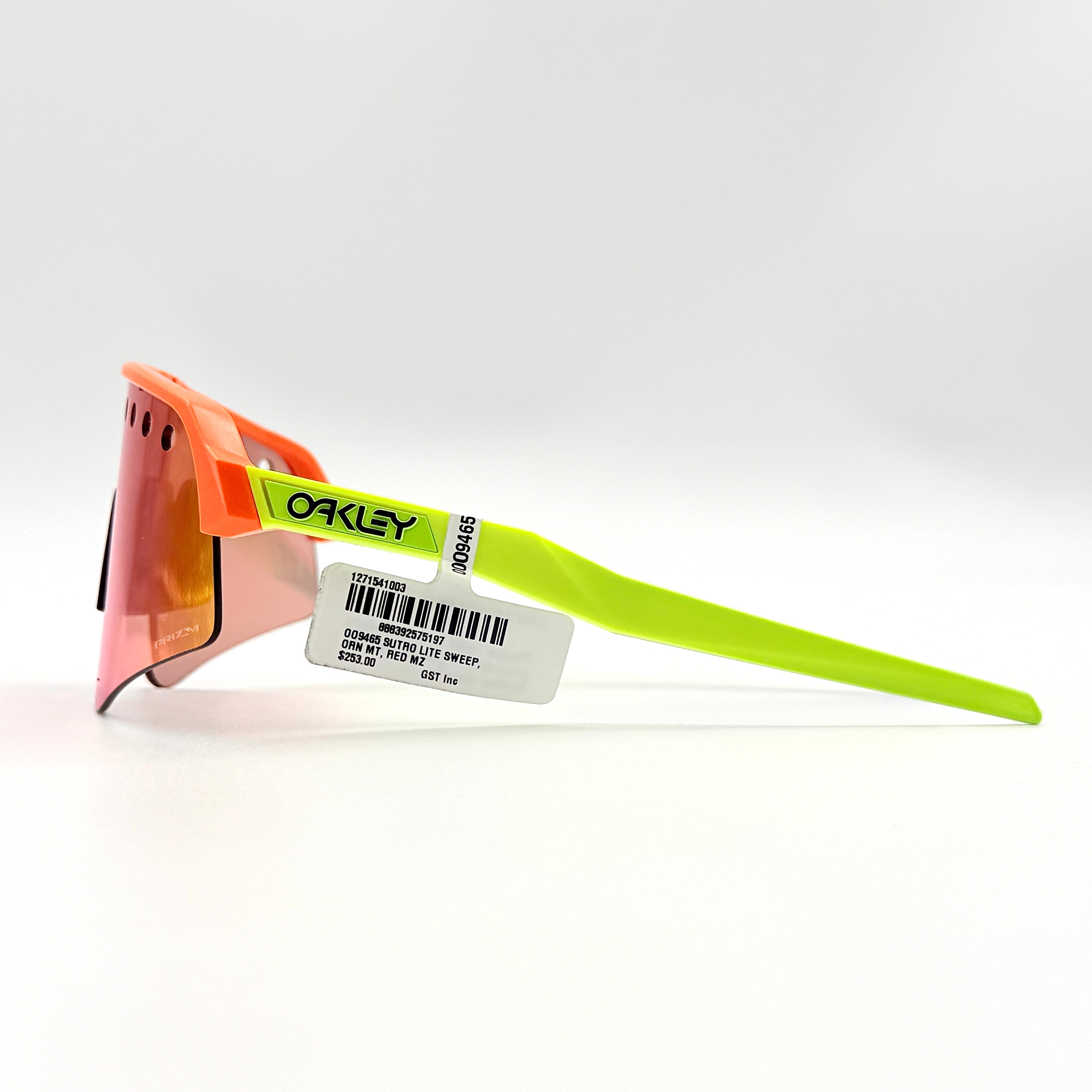 Oakley Sutro Lite Sweep sunglasses in neon yellow and orange with Prizm Trail Torch shield lens, displayed with box and case.