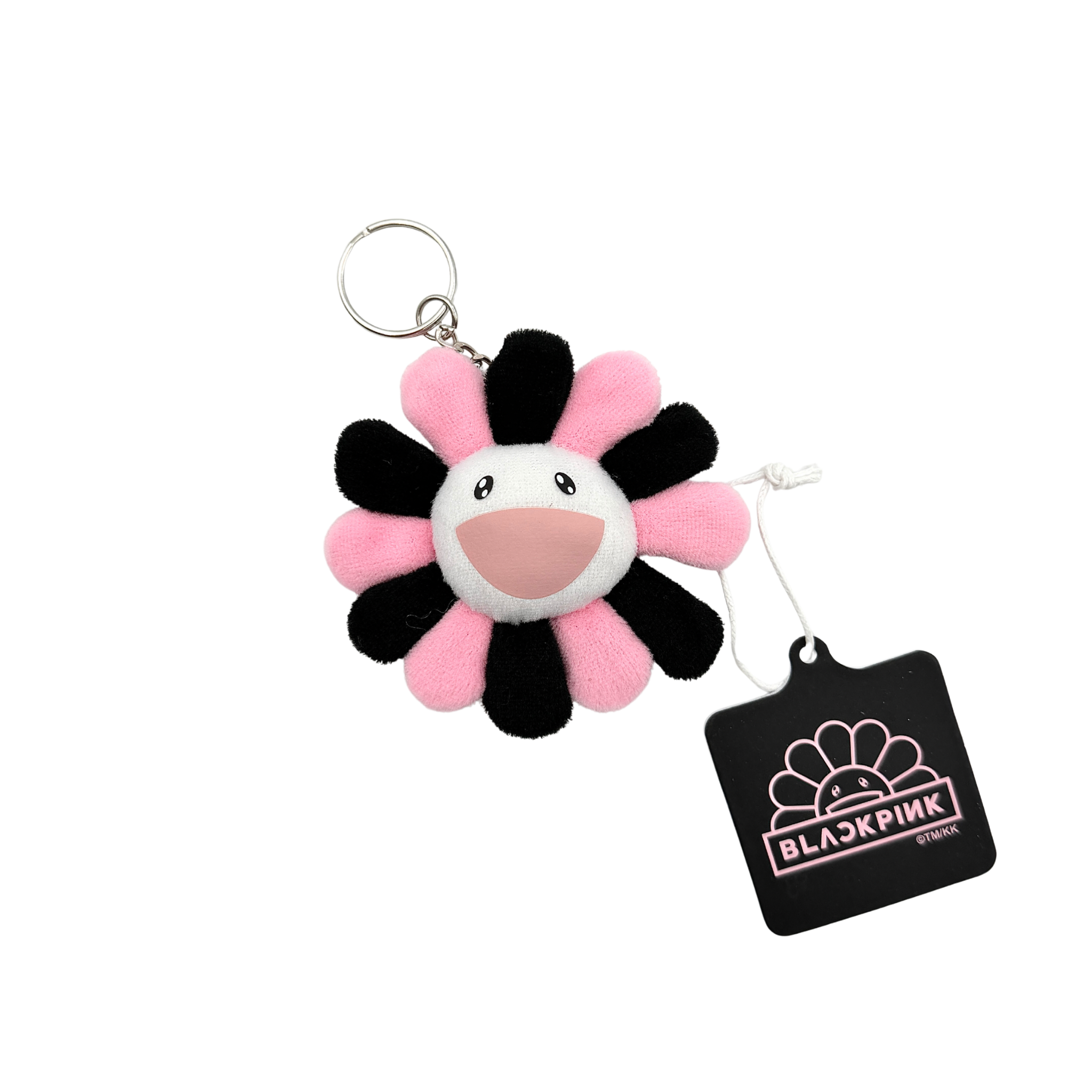 Takashi Murakami x BLACKPINK plush flower keychain in black and pink with smiling face and branded tag.