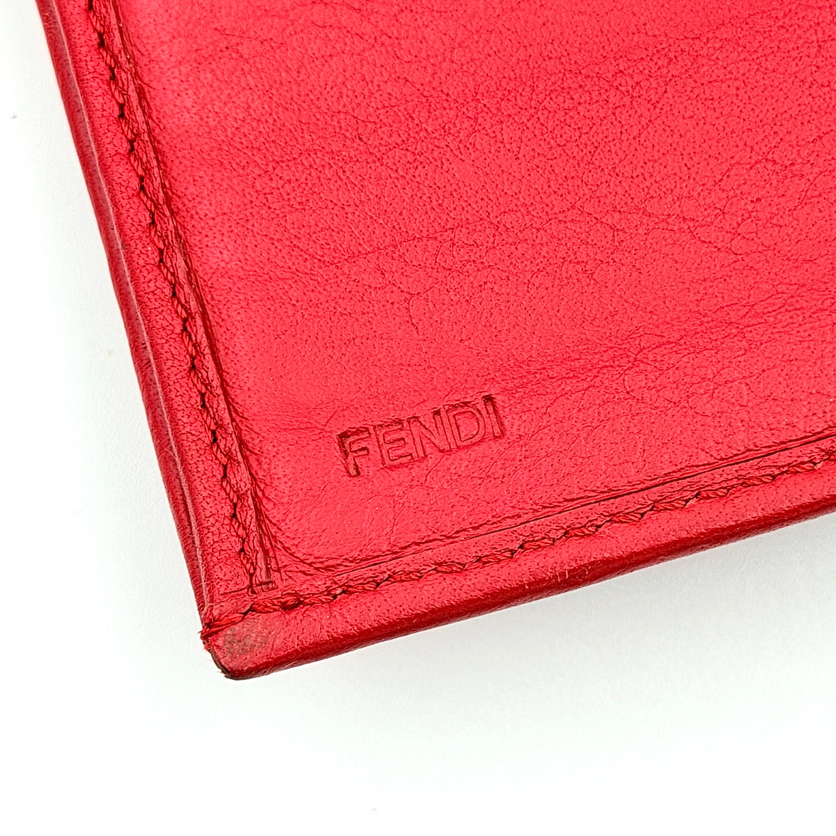 Fendi FF Logo Buckle Flap Continental Wallet in red leather with gold hardware, displayed closed on a white background.