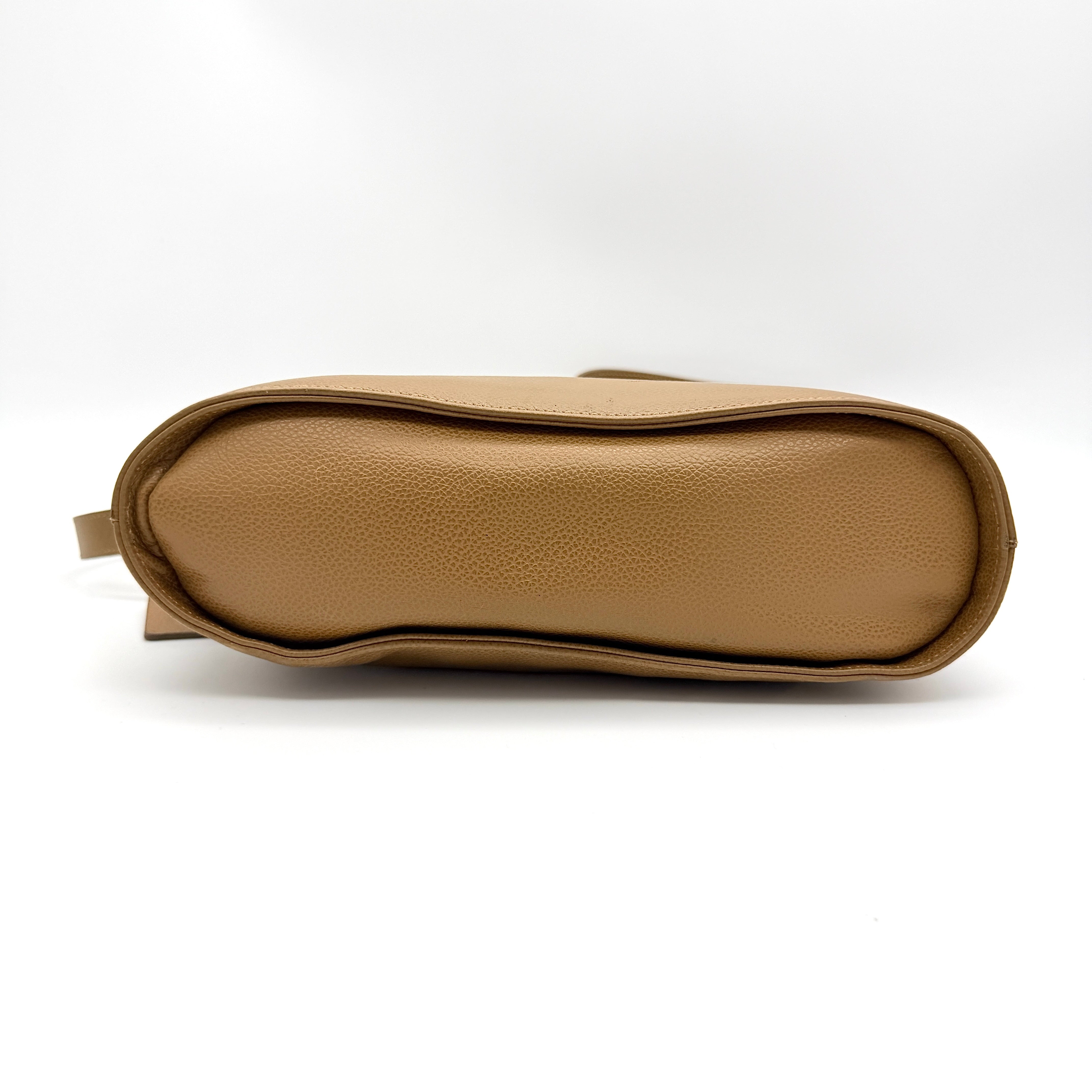 Coach tan leather crossbody bag with gold-tone hardware and adjustable strap, photographed on a white background.