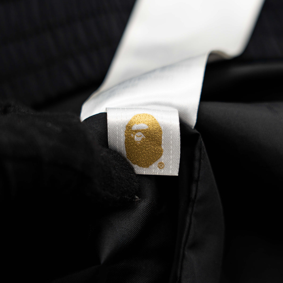 BAPE A Bathing Ape black and white logo track jacket with bold panel detailing, shown laid flat.