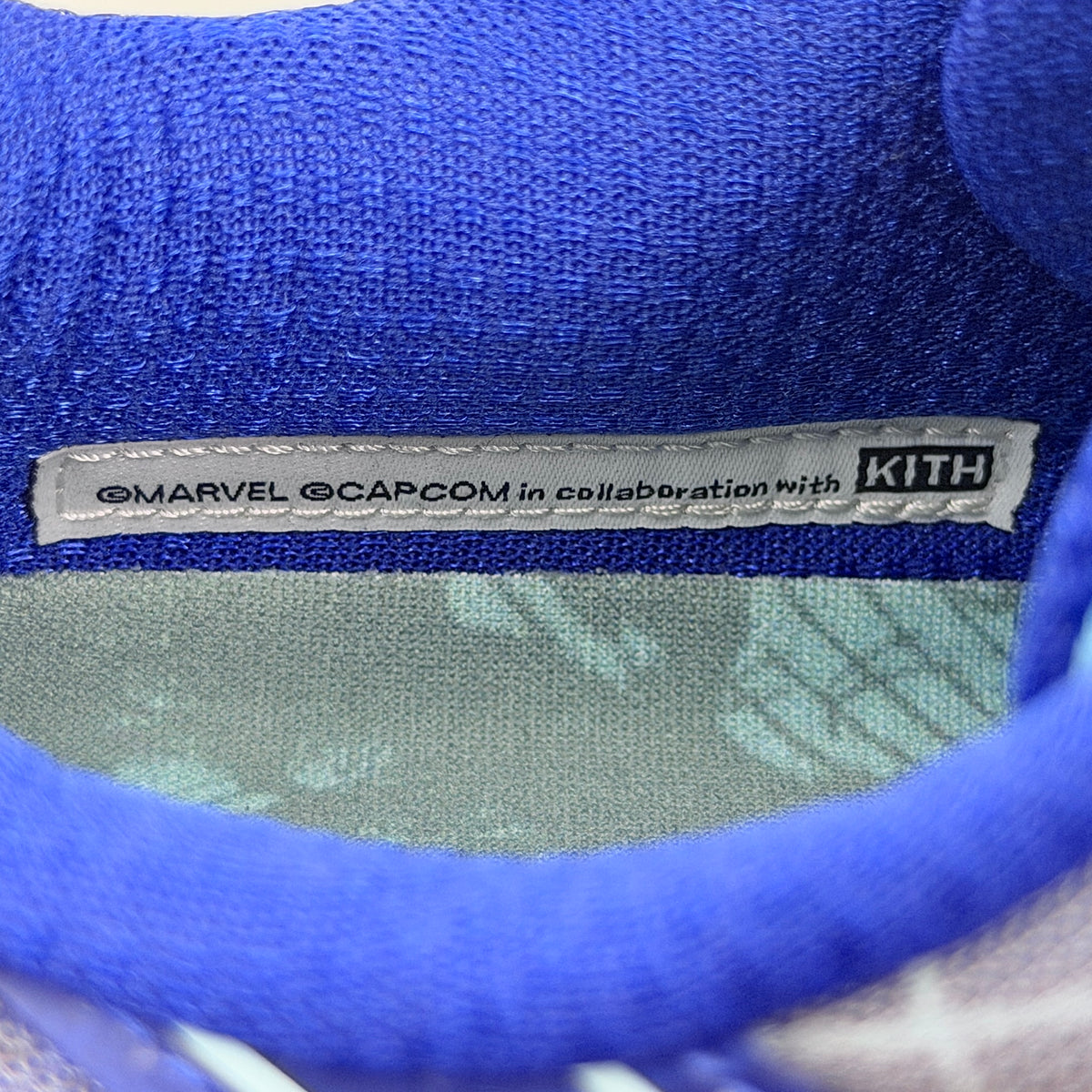 ASICS x KITH Gel-Nimbus 10.1 Mega Man sneakers in bold blue and silver, displayed with extra laces and distinctive collaboration details.