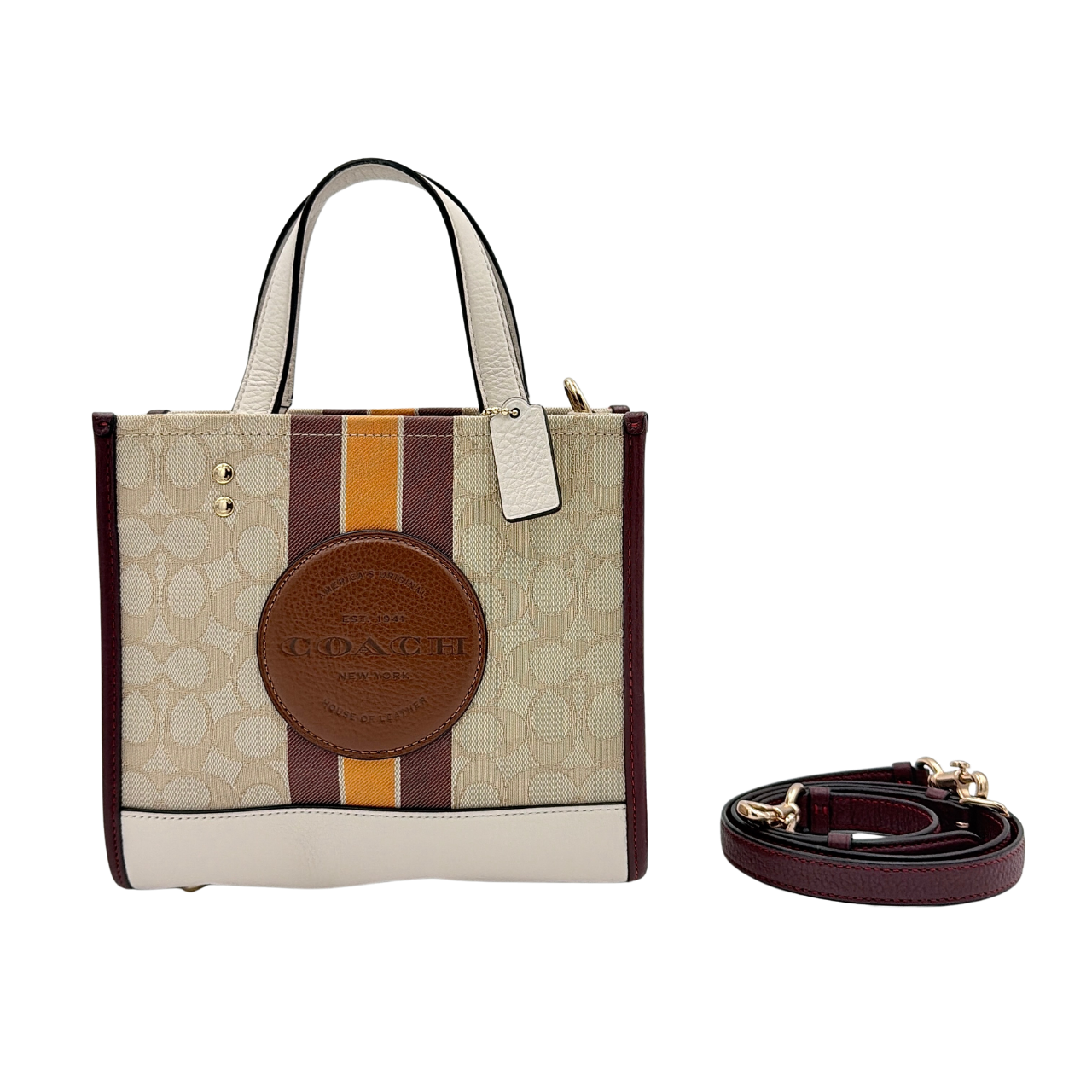 Coach Signature Dempsey 22 Stripe Tote Bag in beige canvas with bold vertical stripes, leather trims, logo patch, and detachable strap.