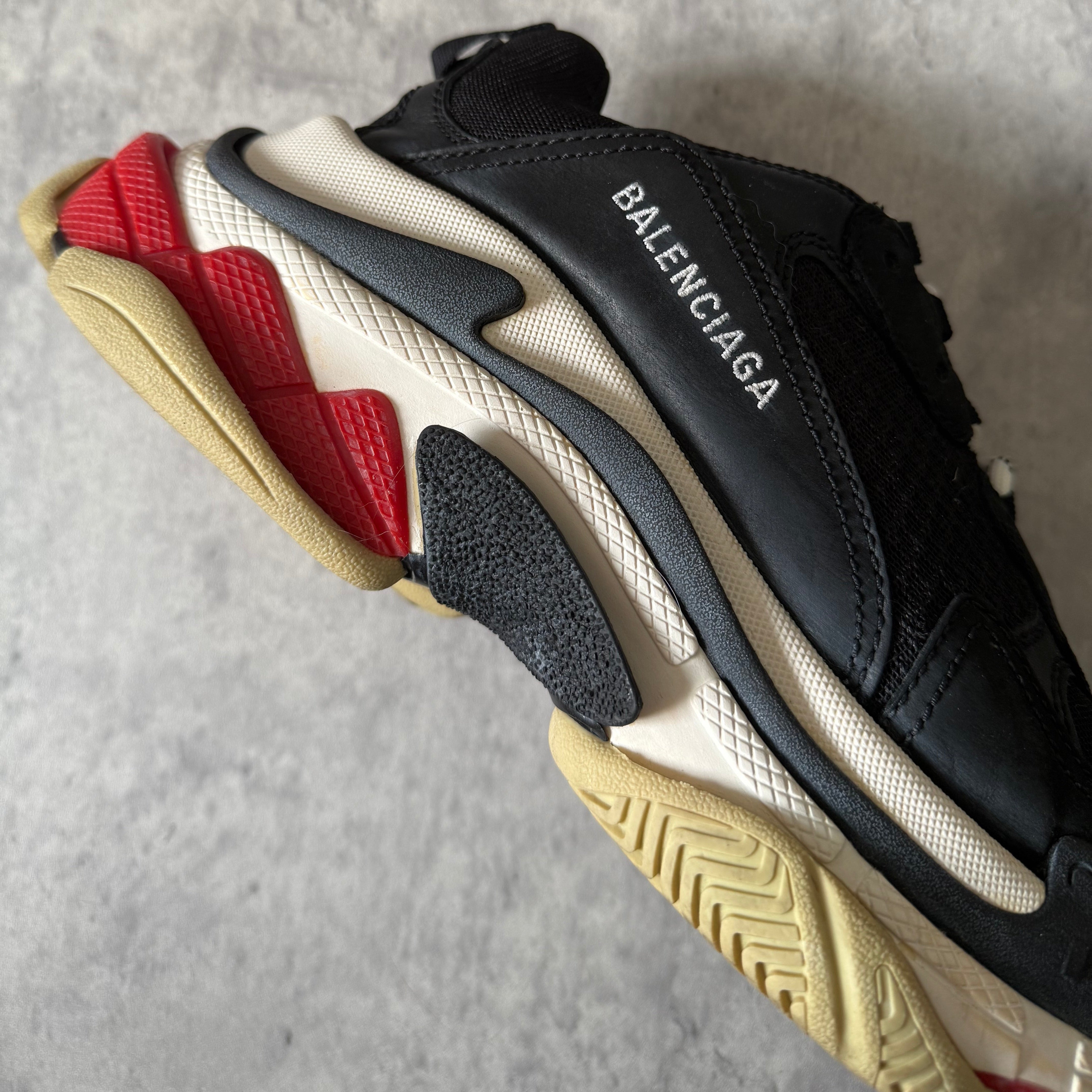 Balenciaga Triple S Black White Red sneakers, featuring layered mesh and leather upper, distressed sole, and oversized silhouette with embroidered size 42.
