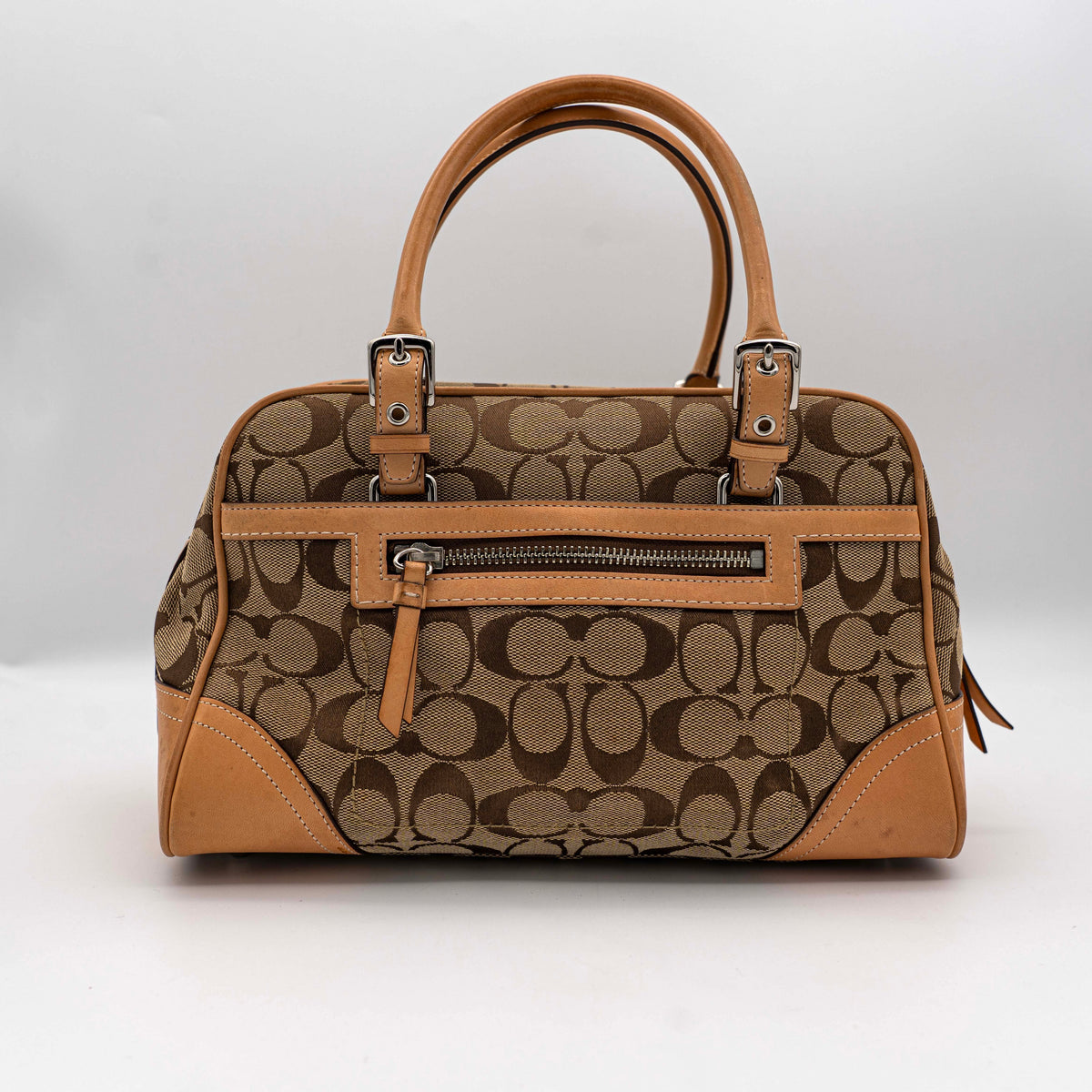 Coach Signature Hampton Satchel Boston Bag in beige and tan canvas with leather trim and silver hardware, styled on a clean background.