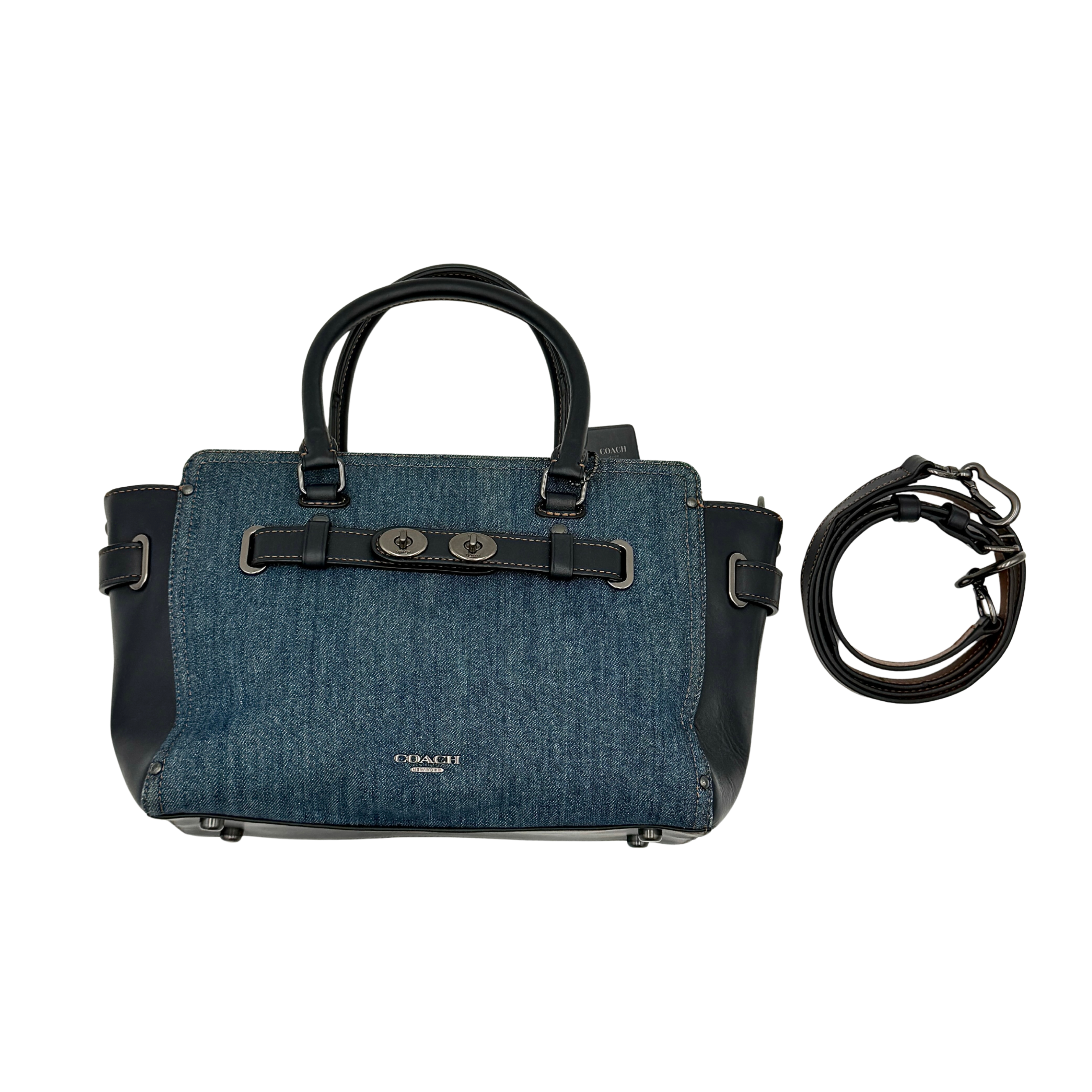 Coach Swagger 27 handbag in blue denim with navy leather trim and detachable strap, featuring prominent double turn-lock hardware and floral interior.