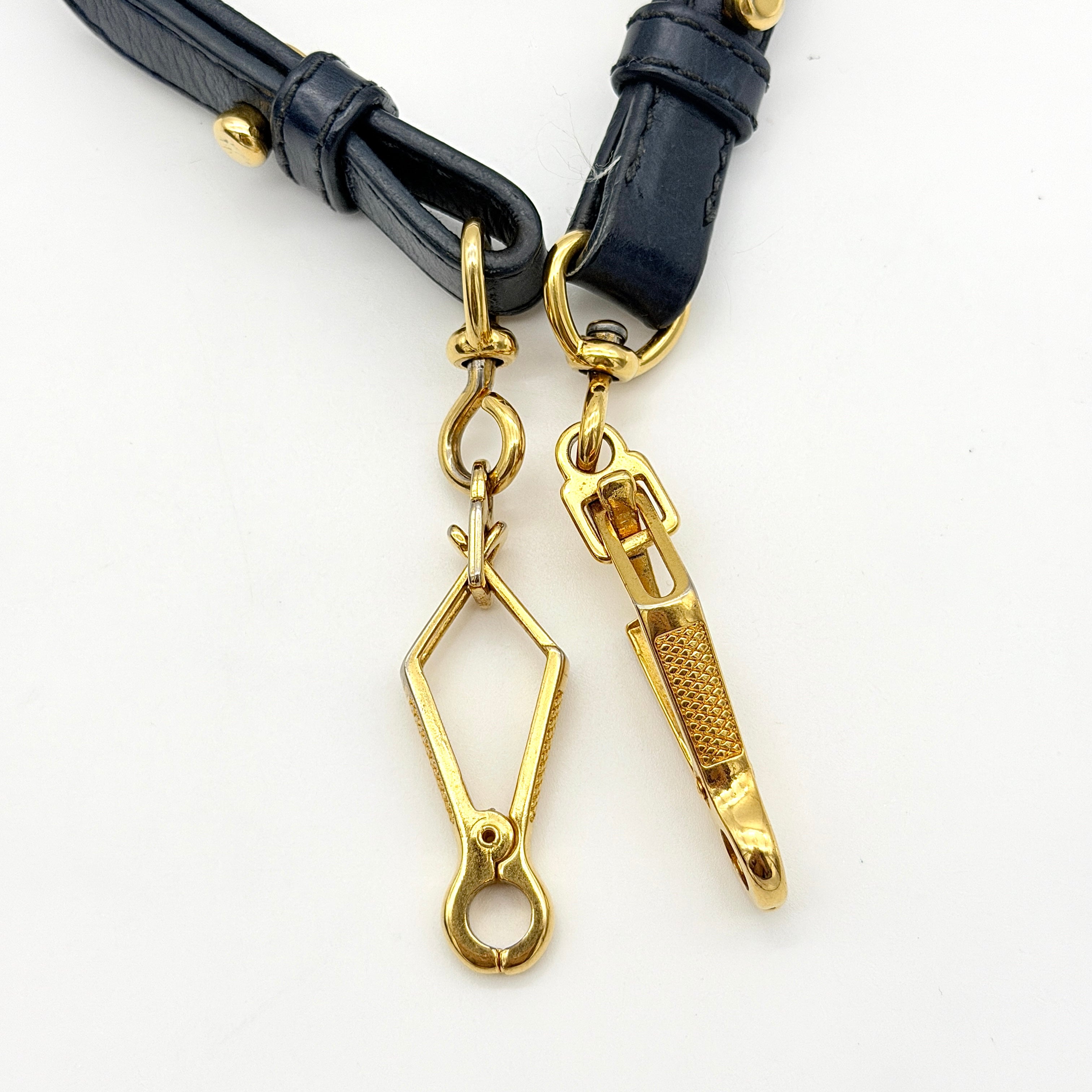 Miu Miu navy blue Vitello Lux Bow Satchel with gold-tone hardware, detachable strap, and dust bag.
