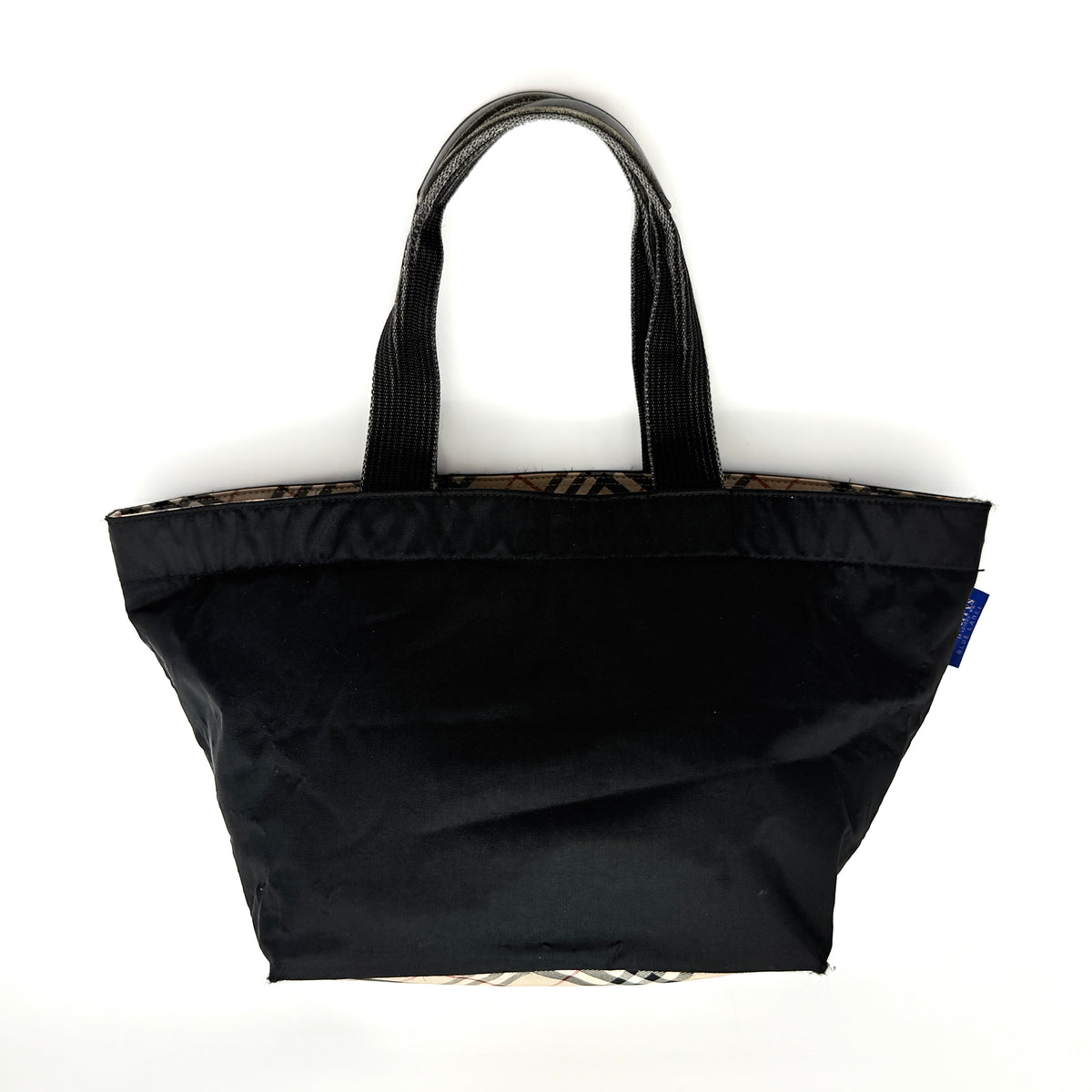Burberry Blue Label Nova Check tote bag in black nylon with beige checked base and webbed handles, shown on white background.