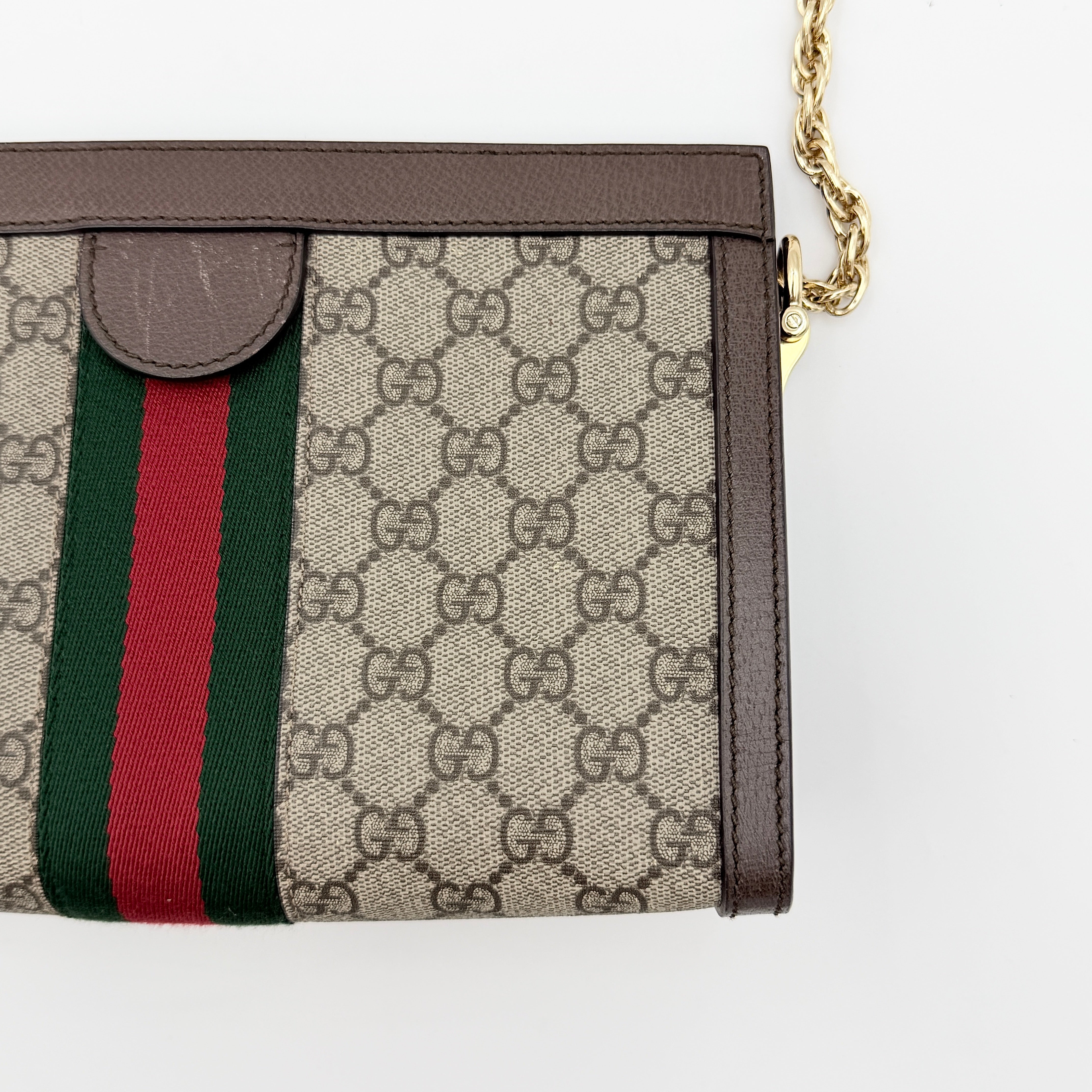 Gucci Ophidia GG Supreme crossbody bag in beige canvas with brown leather trim, signature web stripe, and gold chain strap.