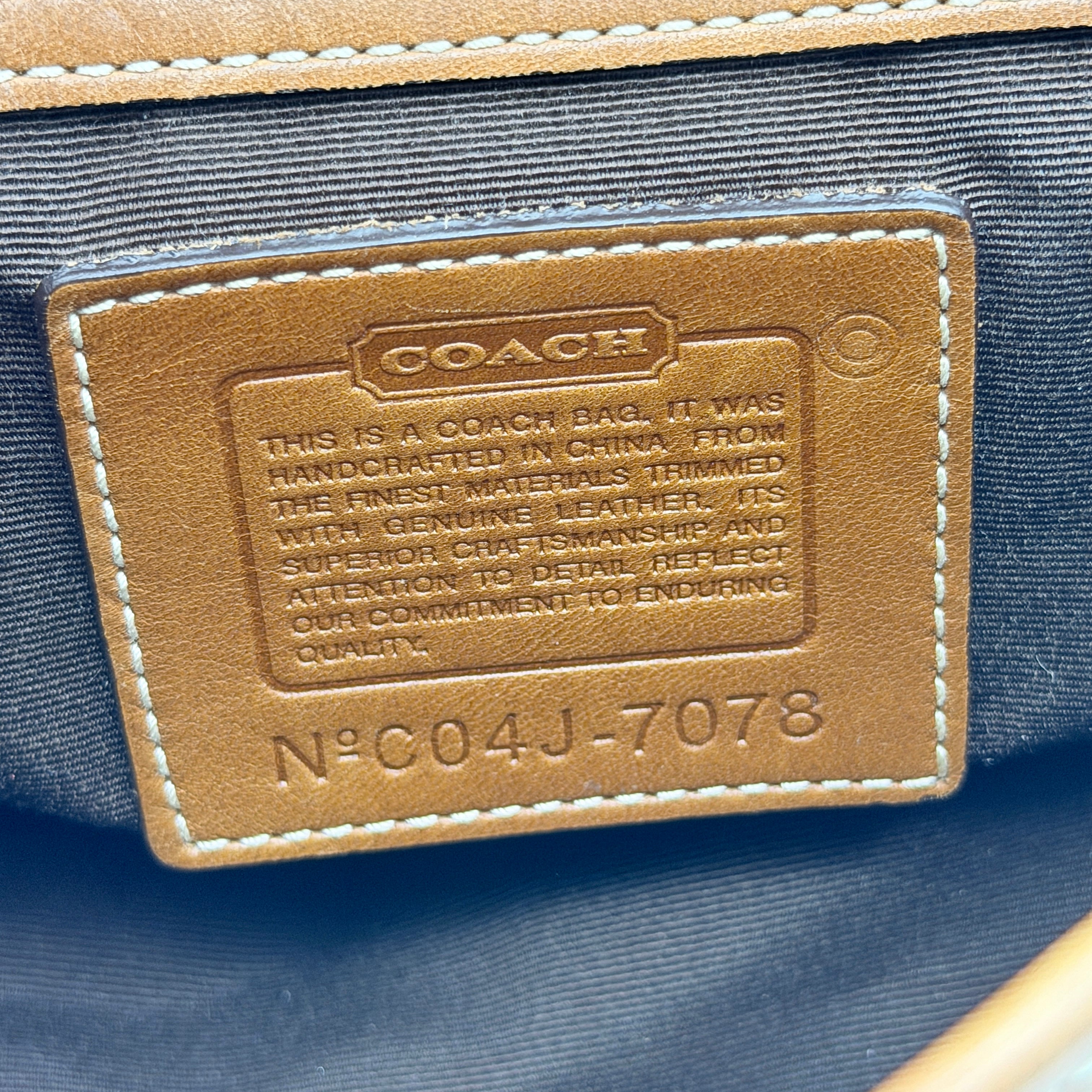 Coach Signature Soho Shoulder Bag in beige and tan monogram canvas with tan leather trim, shown on white background.