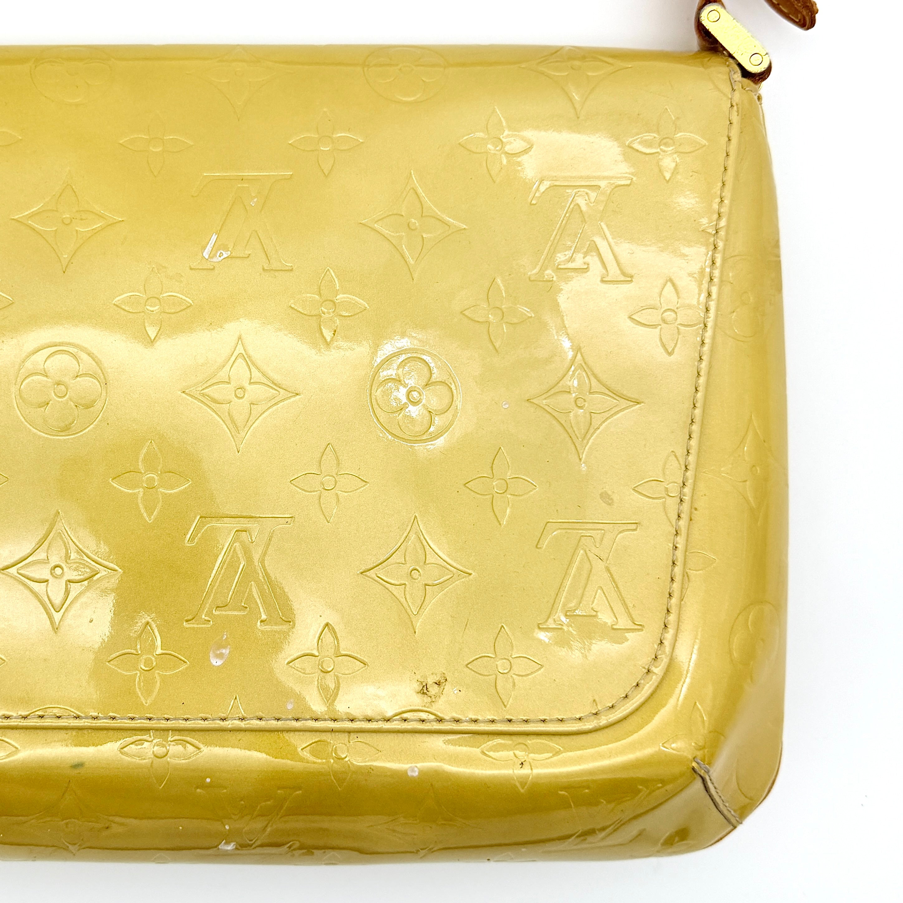 Louis Vuitton Thompson Street bag in yellow Monogram Vernis leather with adjustable shoulder strap and gold-tone hardware.