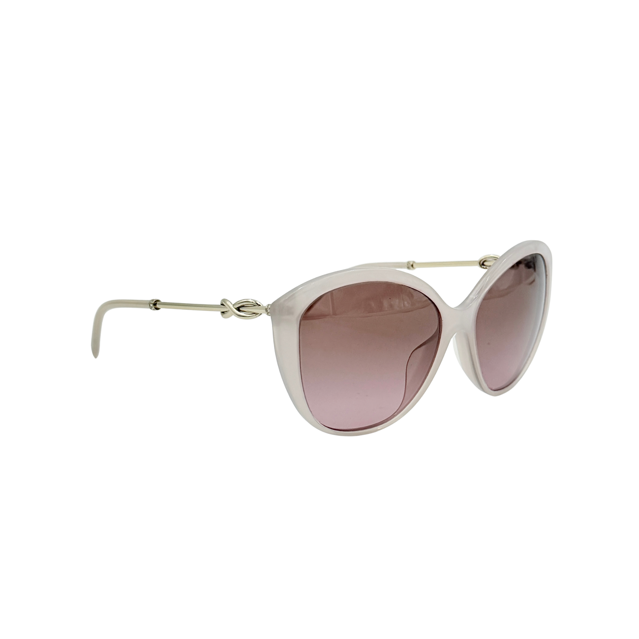 Tiffany & Co. TF4144 sunglasses in pink with gold-tone knot detail arms, shown with signature blue case.