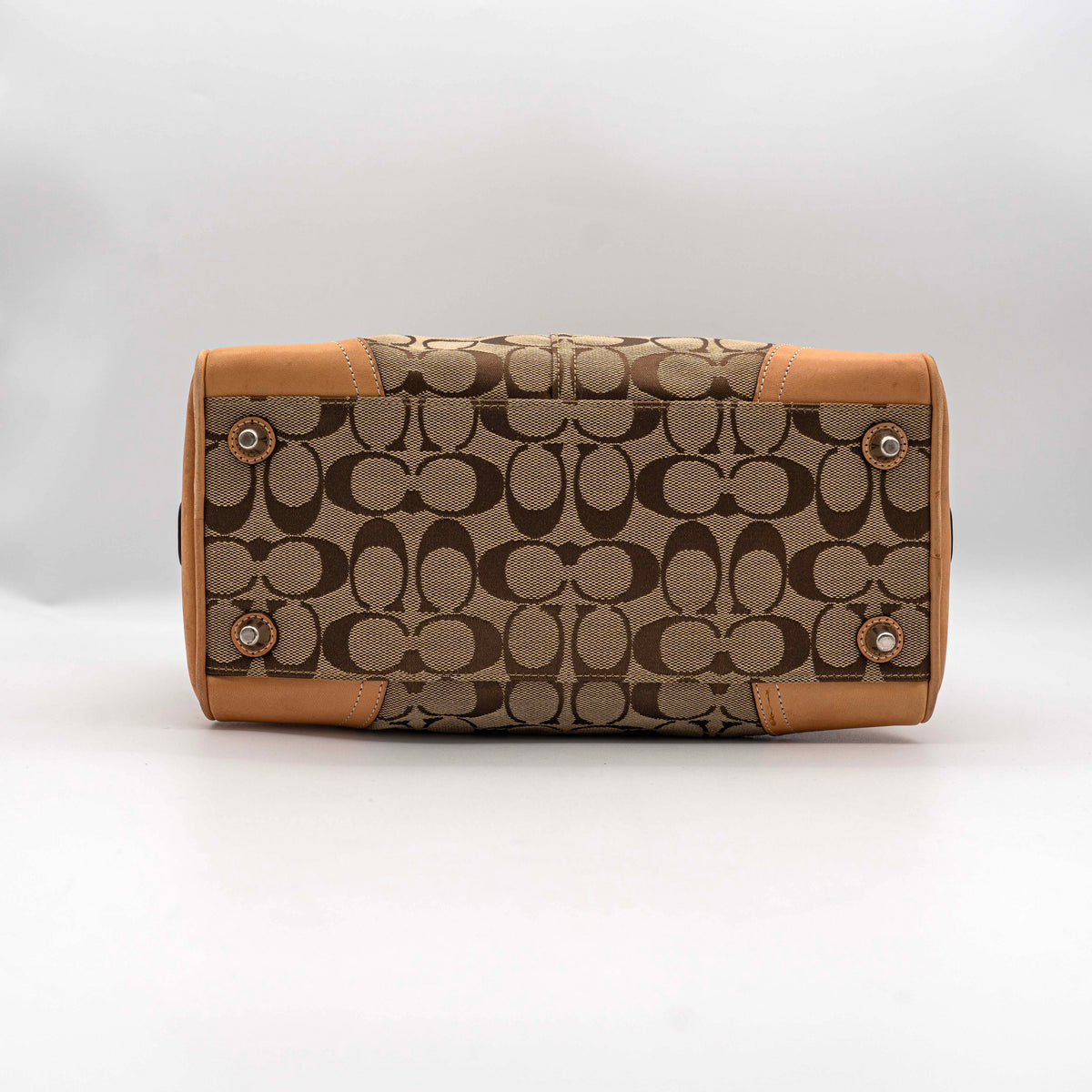 Coach Signature Hampton Satchel Boston Bag in beige and tan canvas with leather trim and silver hardware, styled on a clean background.