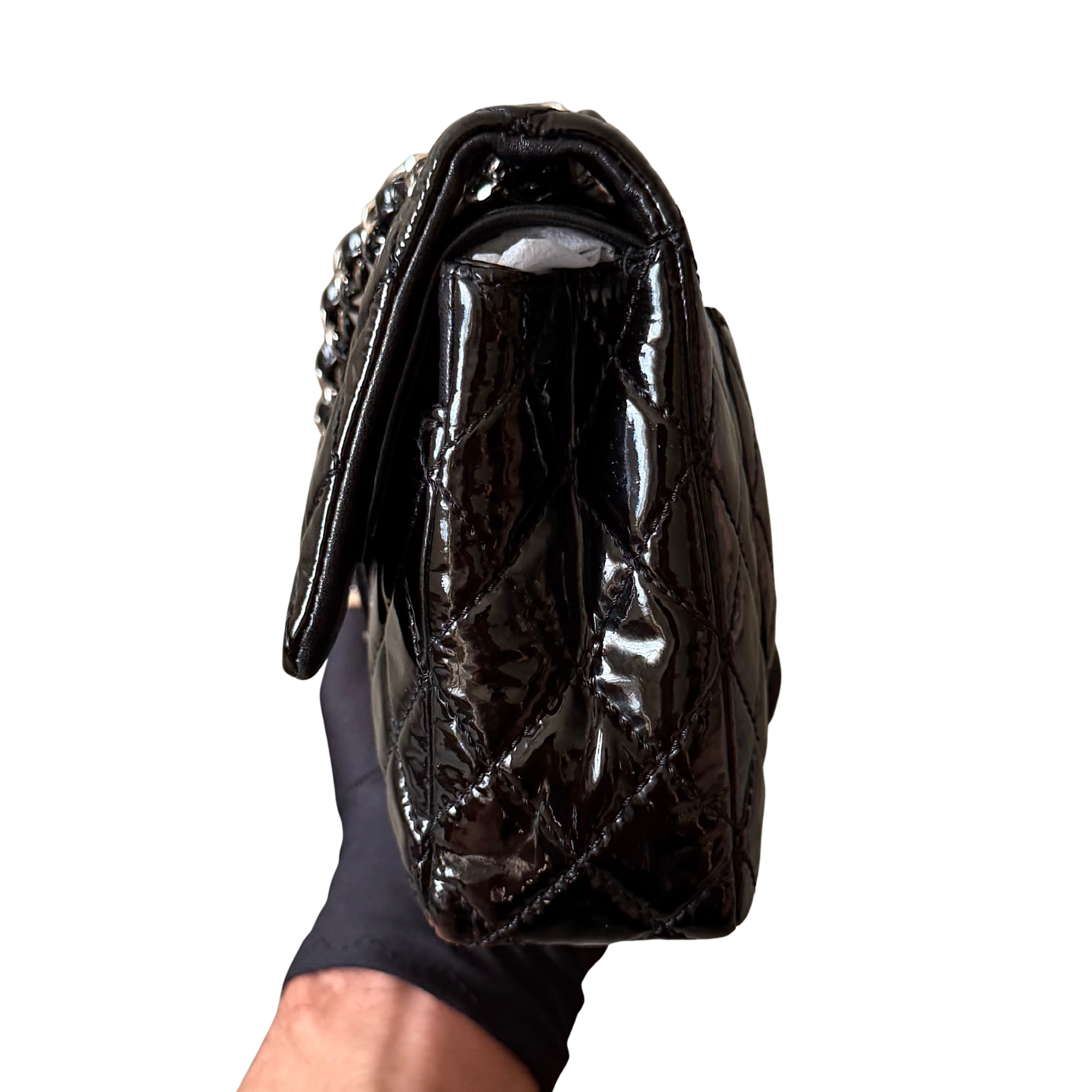 Chanel 25 Matelasse Double Flap bag in glossy black patent leather with silver-tone hardware and quilted finish.