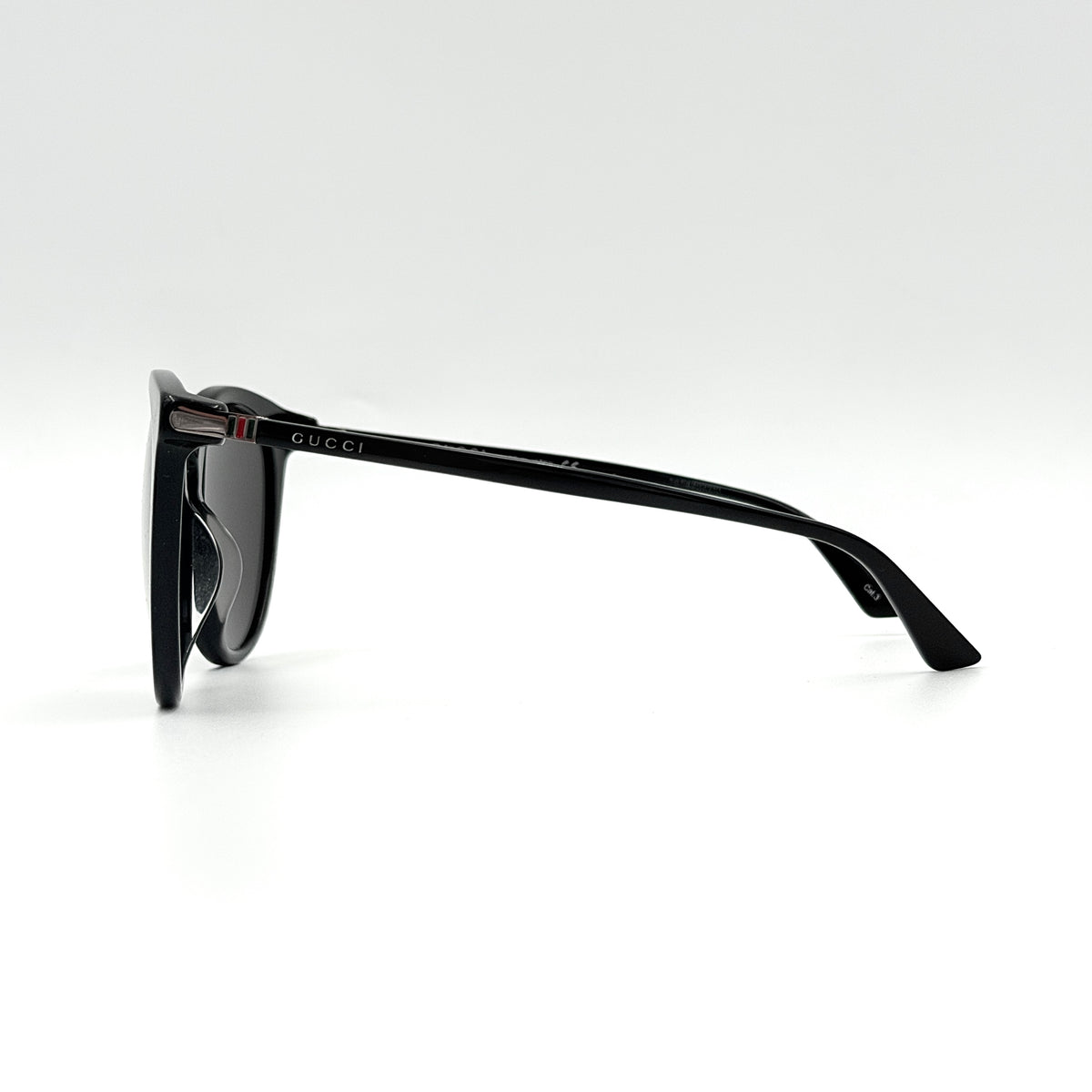 Gucci GG0064SK 001 black round sunglasses with smoky lenses, shown with original burgundy velvet case and pouch.