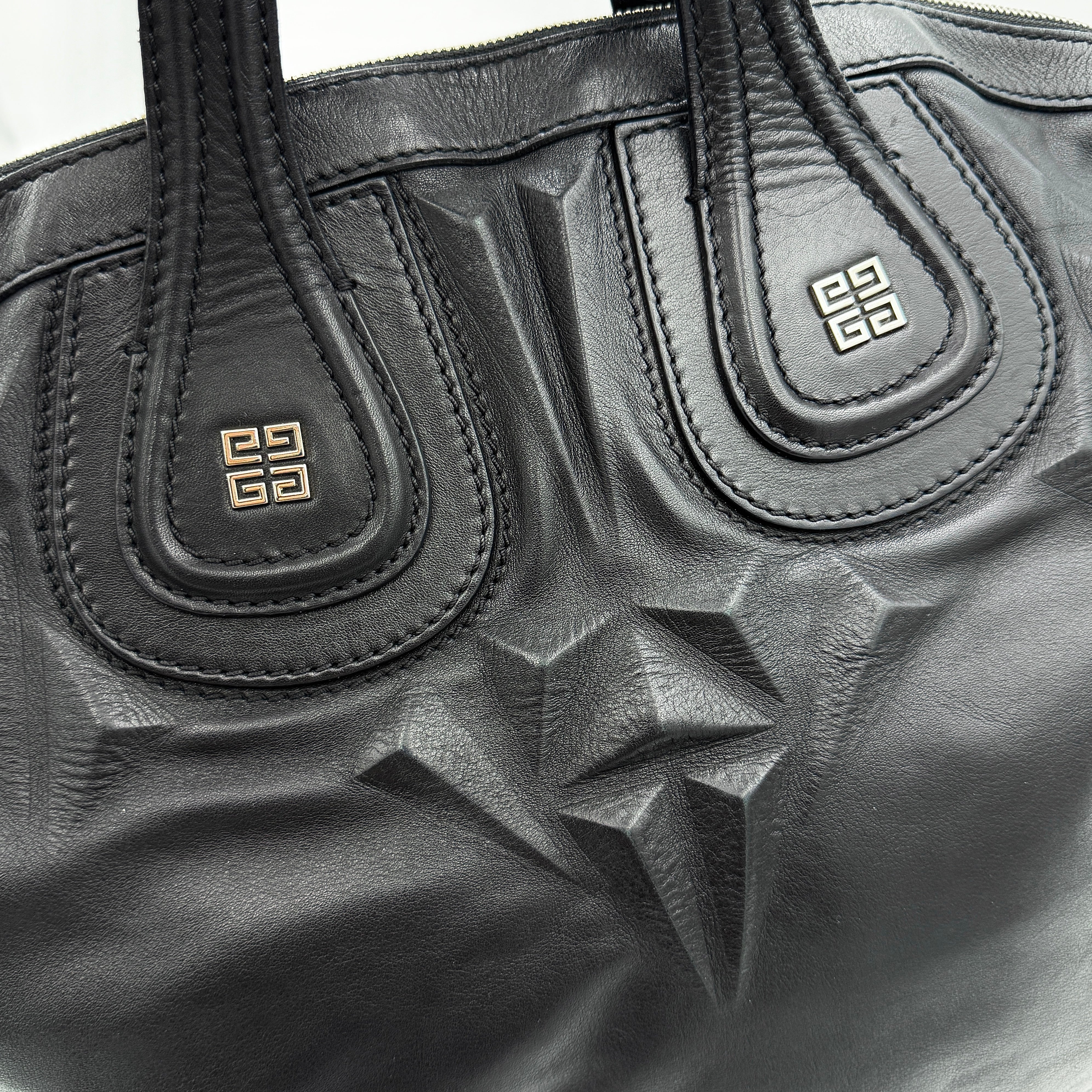 Givenchy 2Way Nightingale Handbag in black leather with detachable strap and striking front motif.