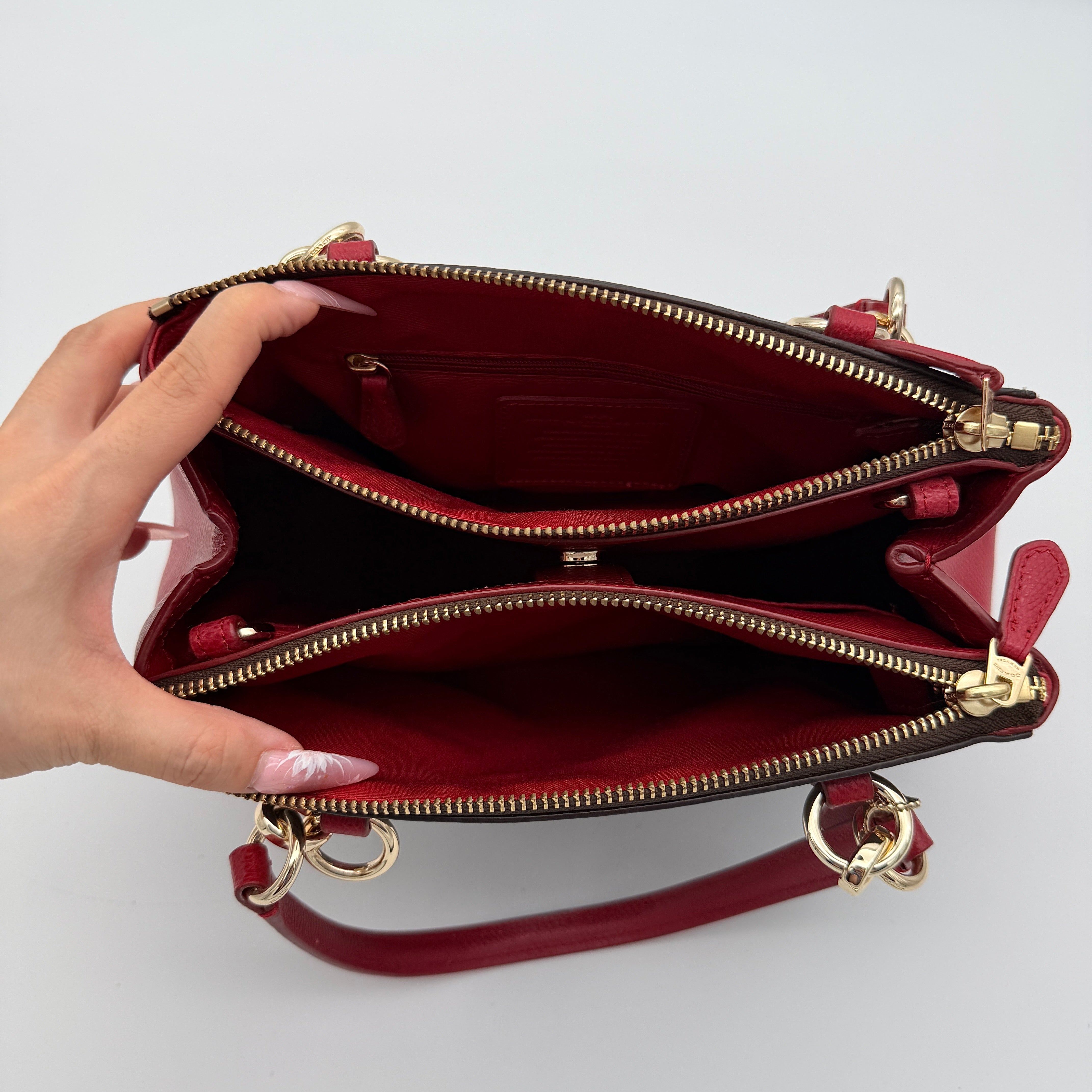Coach 2Way Christie Carryall in brown coated canvas with red leather handles and sides, gold hardware, shown with detachable strap.