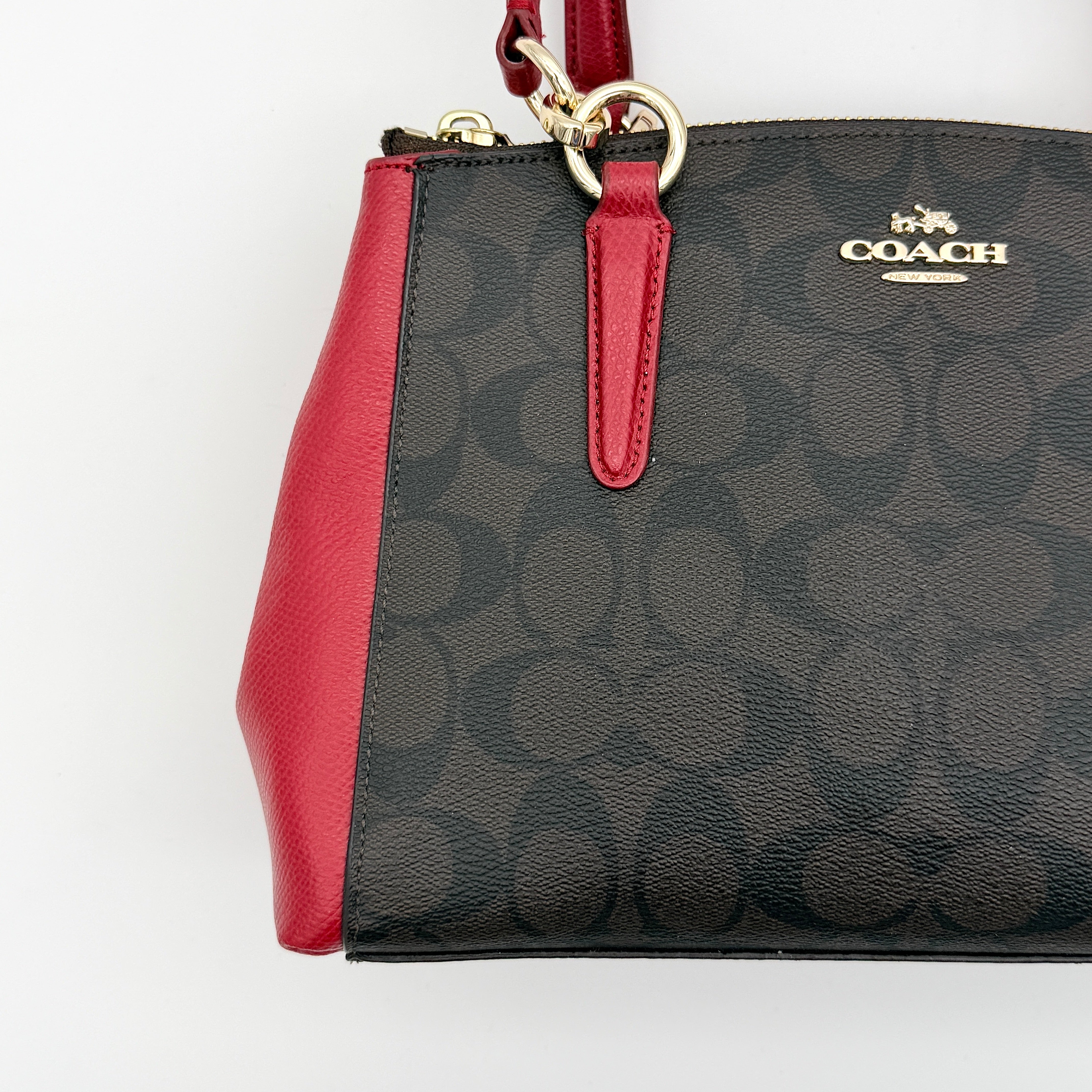 Coach 2Way Christie Carryall in brown coated canvas with red leather handles and sides, gold hardware, shown with detachable strap.
