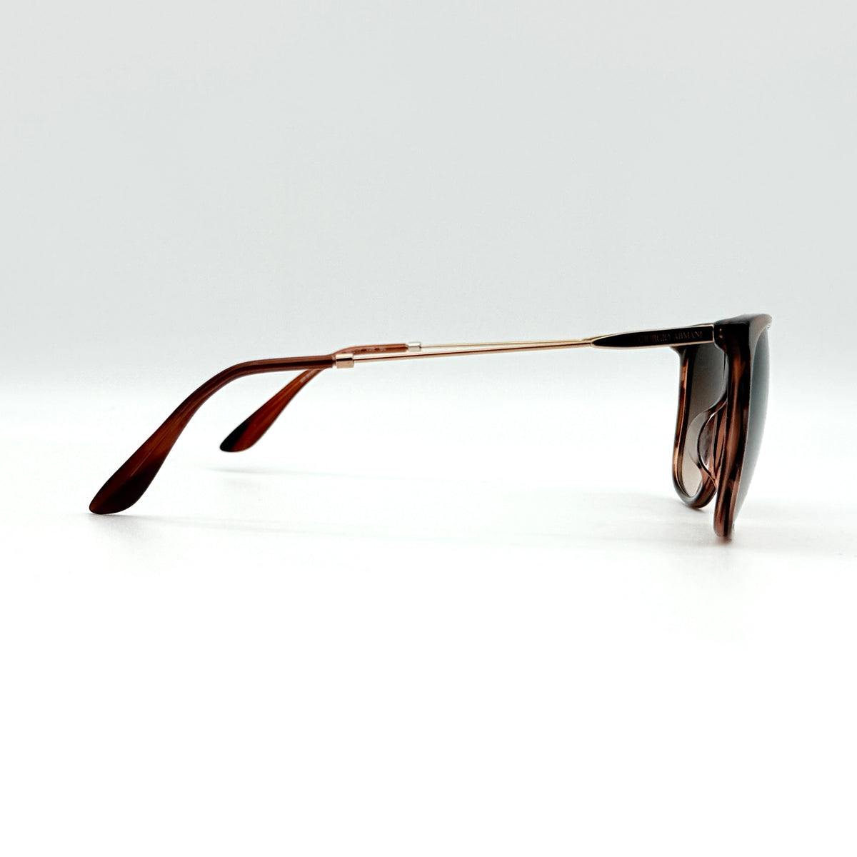 Giorgio Armani AR 8080-F sunglasses in brown tortoise with gradient brown lenses and slim gold-tone arms, displayed at an angle.