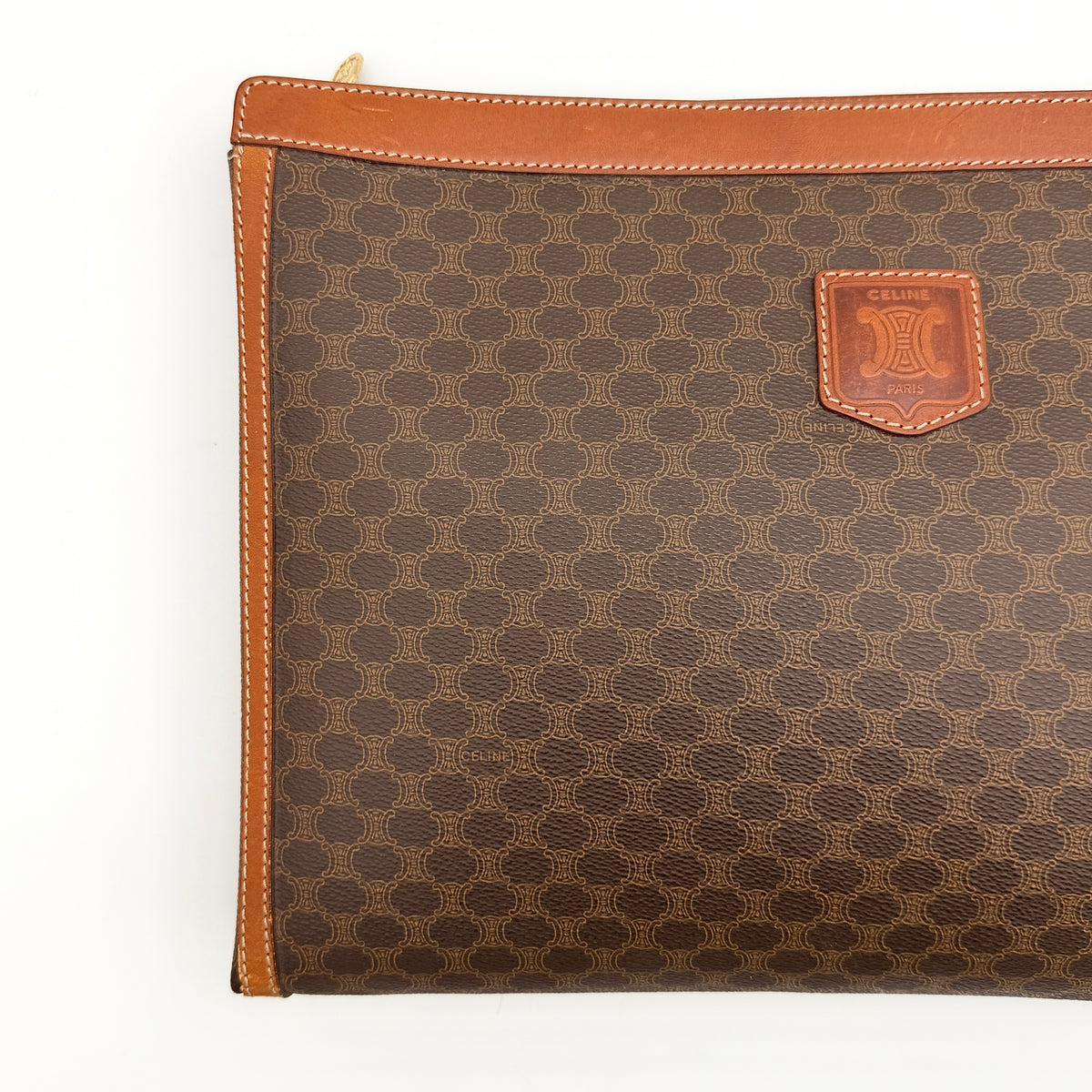 Celine Triomphe Macadam Clutch Bag in brown coated canvas with leather trim, shown against a white background.
