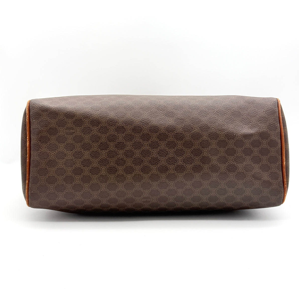 Celine Triomphe Macadam Boston Bag in brown coated canvas with tan leather handles and gold hardware on a white background.