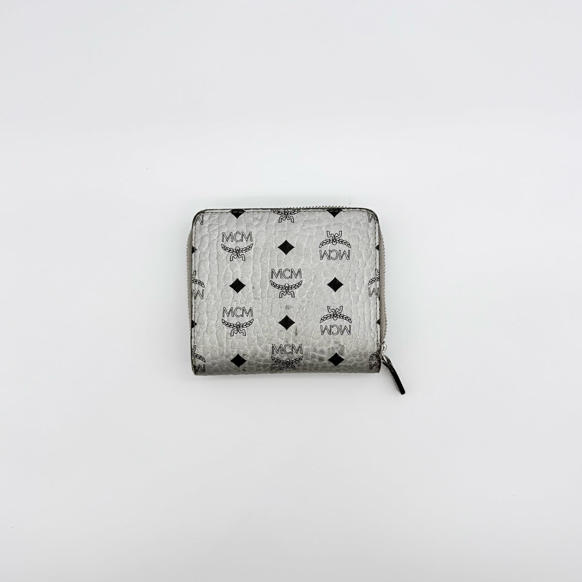 MCM Visetos Monogram wallet in metallic silver with black logo pattern on a clean white background.