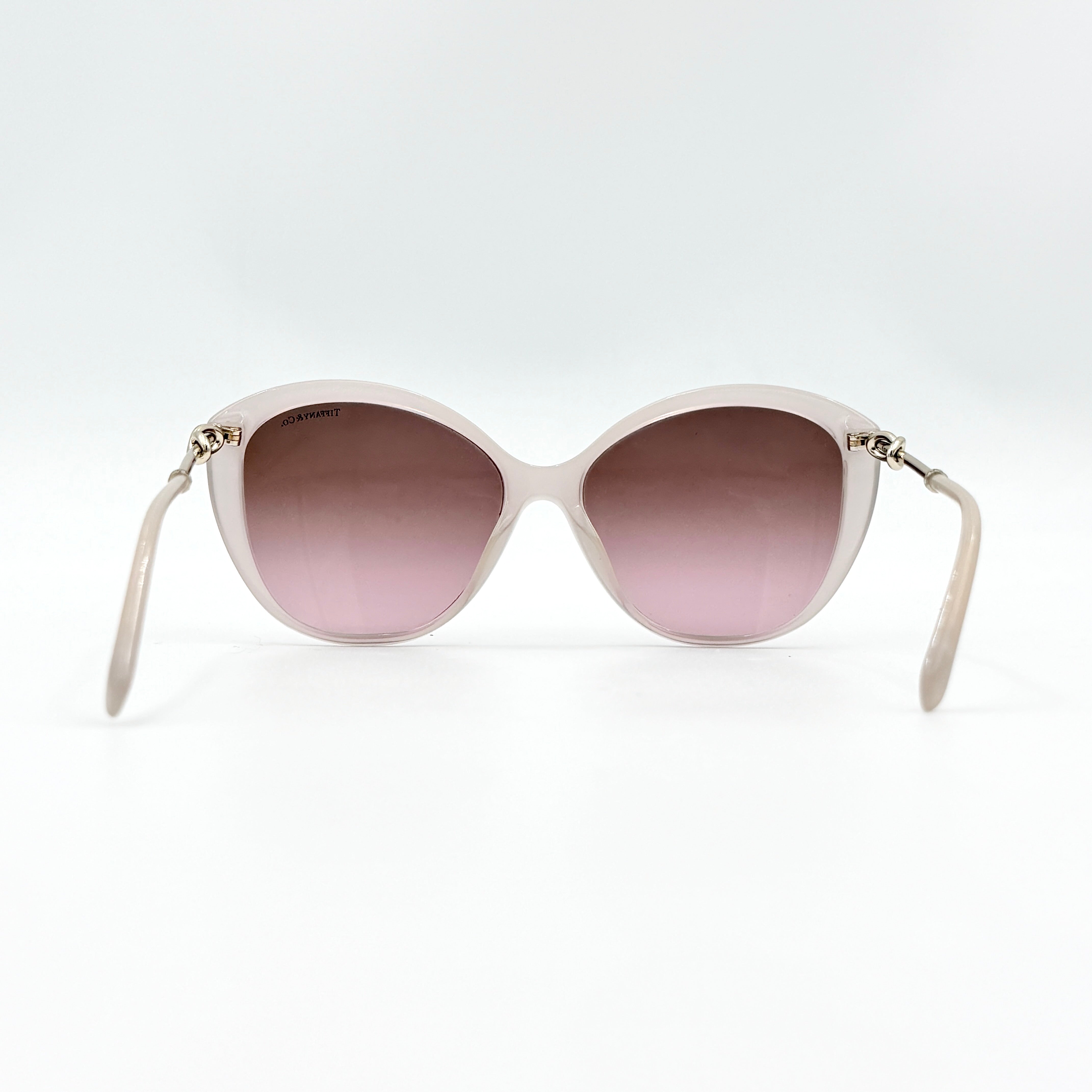 Tiffany & Co. TF4144 sunglasses in pink with gold-tone knot detail arms, shown with signature blue case.