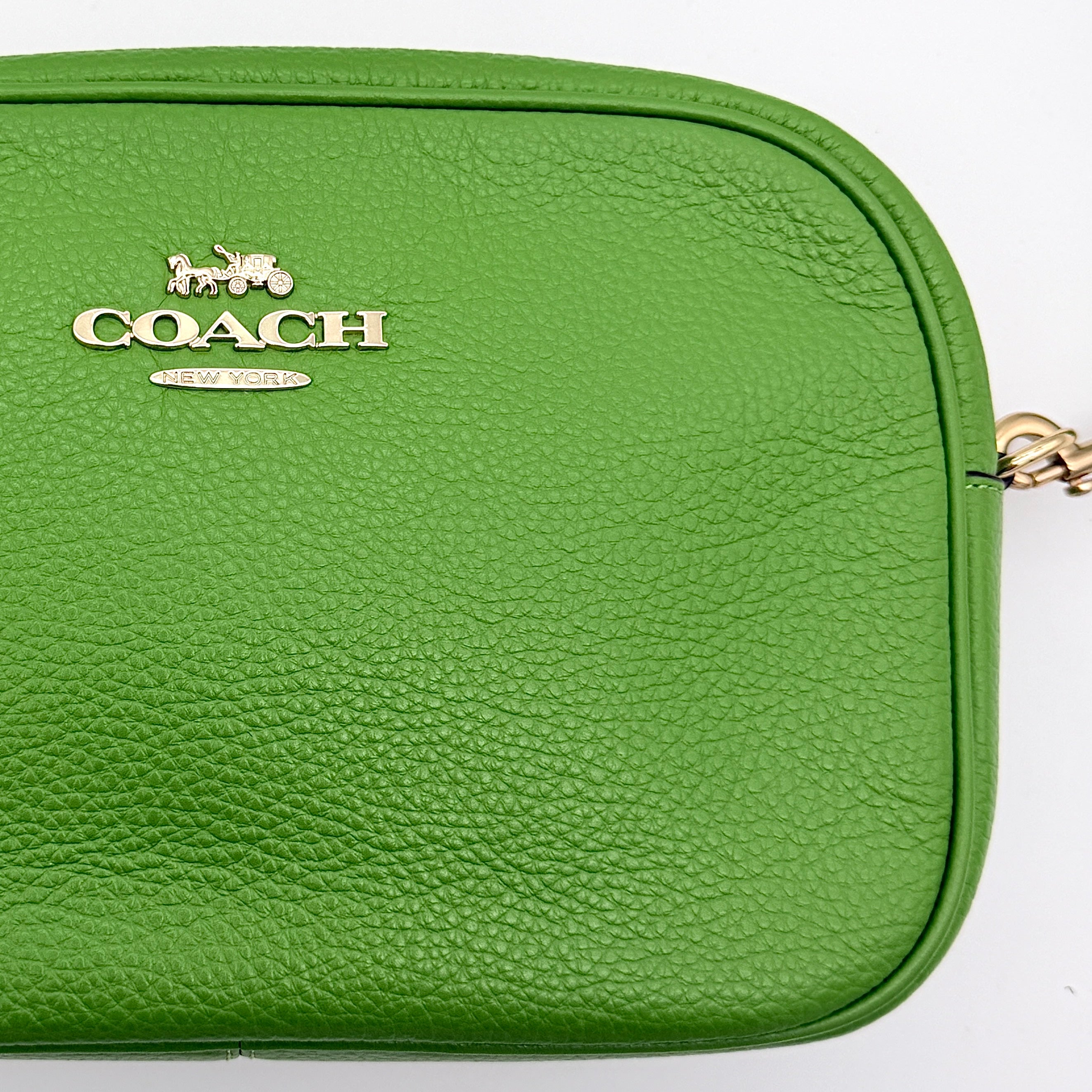 Coach Jamie Camera Crossbody Bag in green textured leather with gold-tone hardware and adjustable strap.